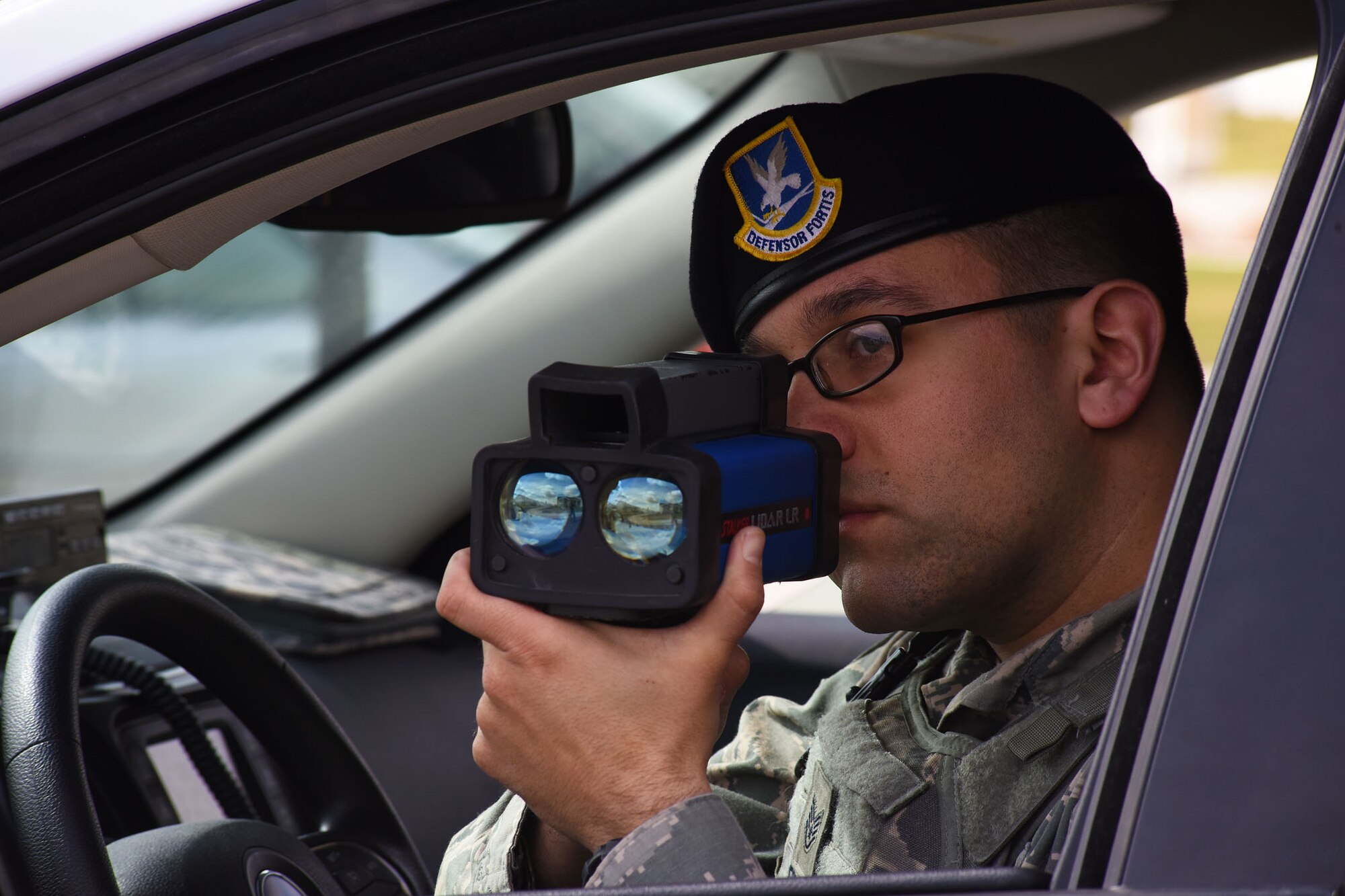 Staff Sgt. Donald Gresham, 341st Security Forces Squadron base defense operations command controller, uses a Laser Illuminated Detection and Ranging gun to check vehicles’ speed while on patrol April 2 at Malmstrom Air Force Base, Mont. While using the LIDAR gun in a traffic stop, Gresham can accurately determine a vehicle’s speed by shining the laser of the LIDAR system on the license plate of the vehicle. (U.S. Air Force photo/Airman 1st Class Collin Schmidt) 