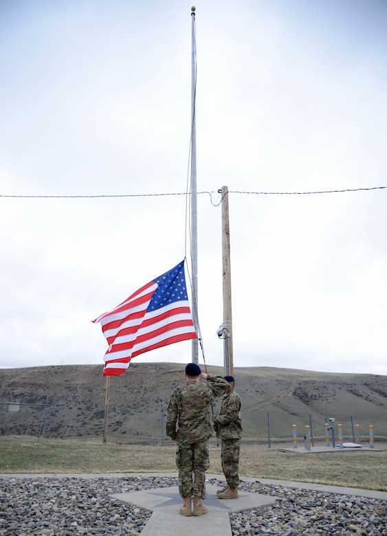341st Missile Security Forces Squadron members lower the American flag March 16, 2015, at a missile alert facility near Malmstrom Air Force Base, Mont. Each day at 4:30 p.m., security forces members perform a small retreat ceremony and fold the flag. (U.S. Air Force photo/Airman 1st Class Dillon Johnston)