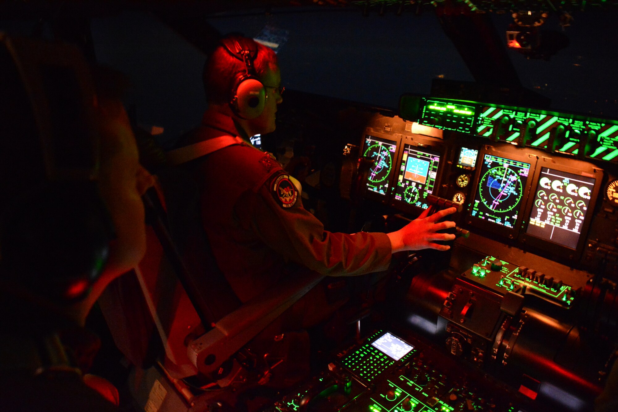 Maj. Jon Flowers, pilot, and Lt. Col. Matt Jones, mission commander, from the 22nd Airlift Squadron at Travis Air Force Base, California, work together April 3 on the flight deck of the C-5M Super Galaxy. (U.S. Air Force photo by Airman 1st Class Amber Carter)