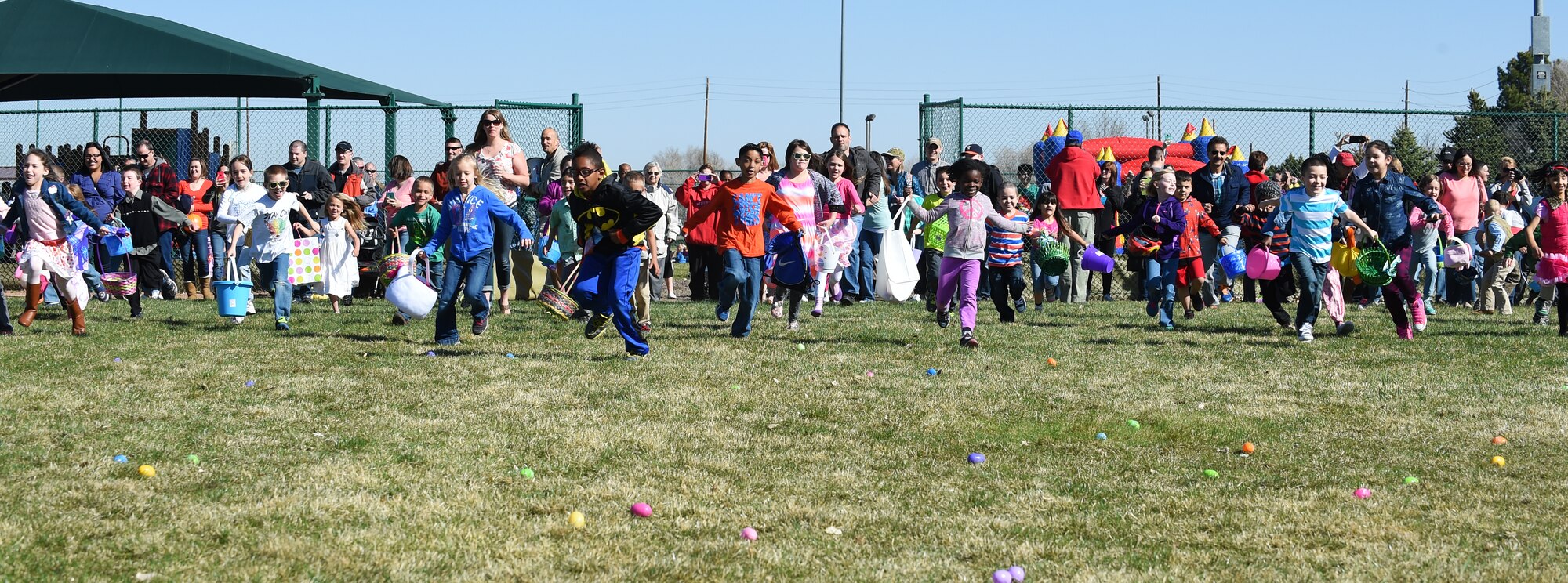 Children take off to hunt for Easter eggs during the Breakfast with Bunny event April 4, 2015, at the softball fields on Buckley Air Force Base, Colo. The event included a free pancake breakfast and Easter egg hunts for different age groups. (U.S. Air Force photo by Airman 1st Class Emily E. Amyotte/Released)