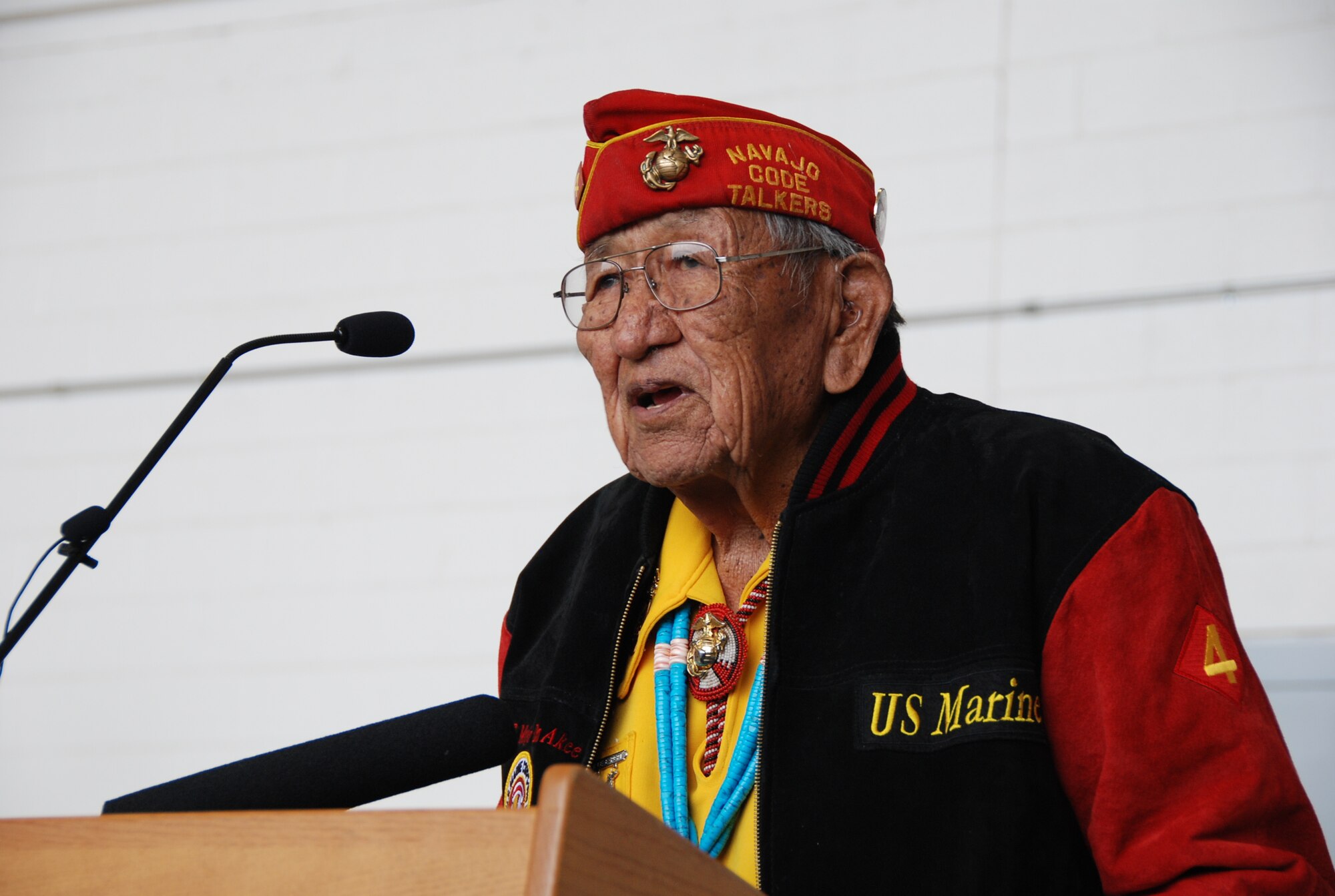 Dan Akee, a Navajo Code Talker, speaks to a crowd Friday, March 20 at Naval Air Station Fort Worth Joint Reserve Base, Texas. During World War II more than 300 Navajo were recruited by the U.S. Marine Corp for the purposes of developing an unbreakable code, which they did so successfully. These Marines were credited with saving thousands of American lives during the war. There are currently less than 30 code talkers living. (U.S. Air Force Photo/Staff Sgt. Melissa Harvey)