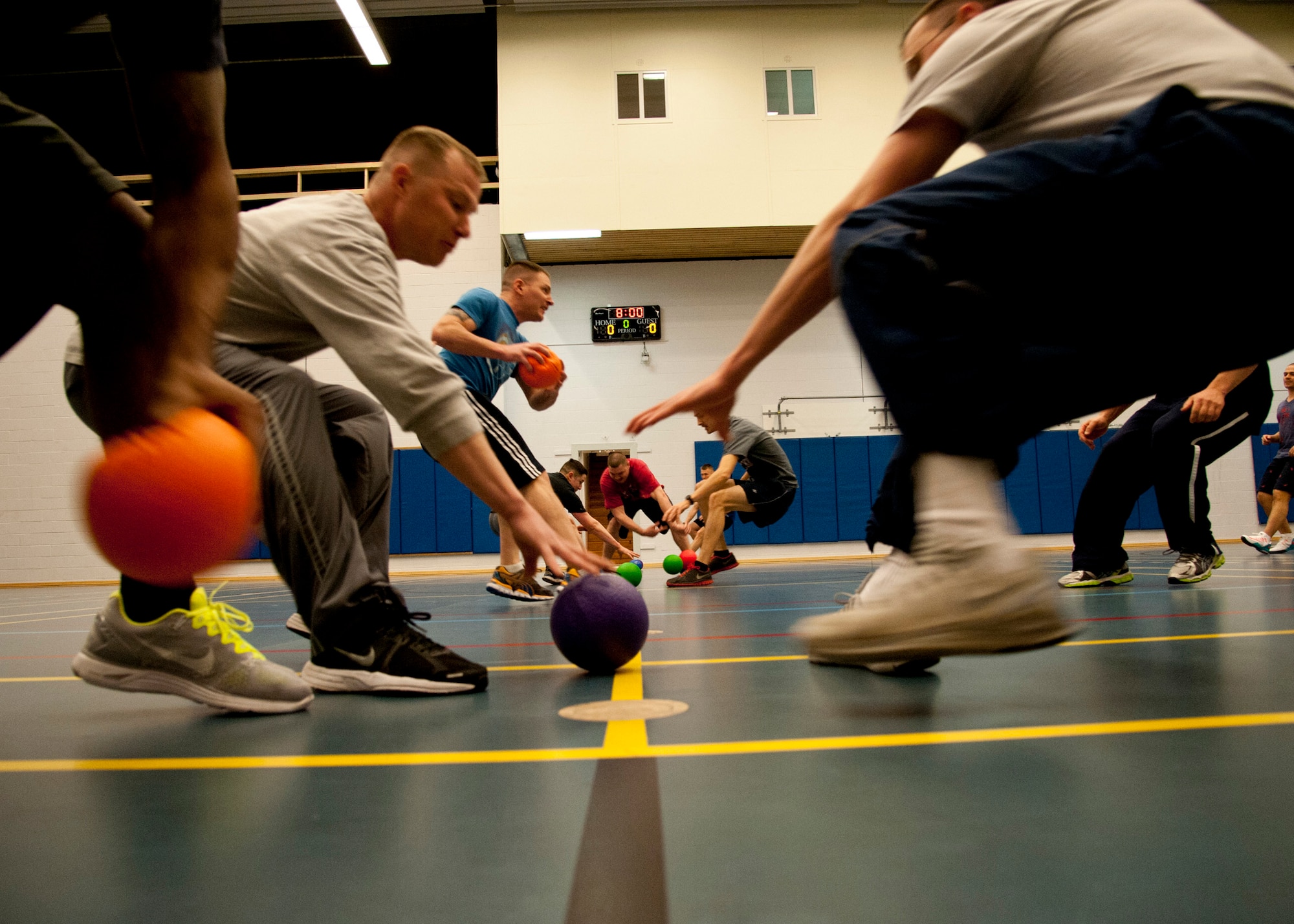 THULE AIR BASE, Greenland – Members of Thule AB race to collect dodgeballs for their team during a dodgeball game at the Thule Fitness Center March 20, 2015. The Rising Six council organizes various morale events on Thule AB, including a once-a-month sports day activity for the members of Team Thule. (U.S. Air Force photo by Senior Airman Tiffany DeNault)