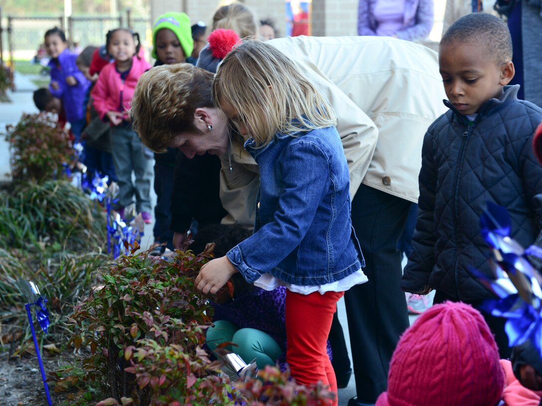 Children and caretakers from the Pershing Child Development Center take part in pinwheel planting as part of Child Abuse Prevention Month at Fort Eustis, Va., April 2, 2015.  The Joint Base Langley-Eustis Family Advocacy Program will host events throughout the month, to show support for military children and to provide parents with lessons and tips.  (U.S. Air Force photo by Senior Airman Kimberly Nagle/Released) 