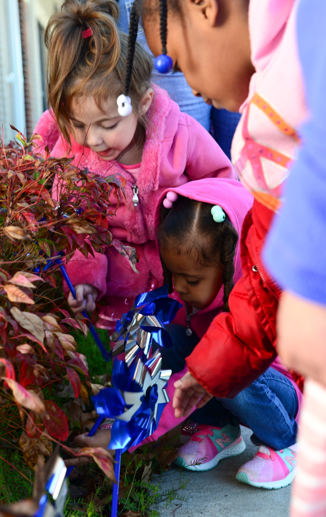 Children from the Pershing Child Development Center plant blue and silver pinwheels to kickoff Child Abuse Prevention Month at Fort Eustis, Va., April 2, 2015. The pinwheel is the national symbol for child abuse prevention and are planted across the nation each April to raise awareness for the month. (U.S. Air Force photo by Senior Airman Kimberly Nagle/Released)