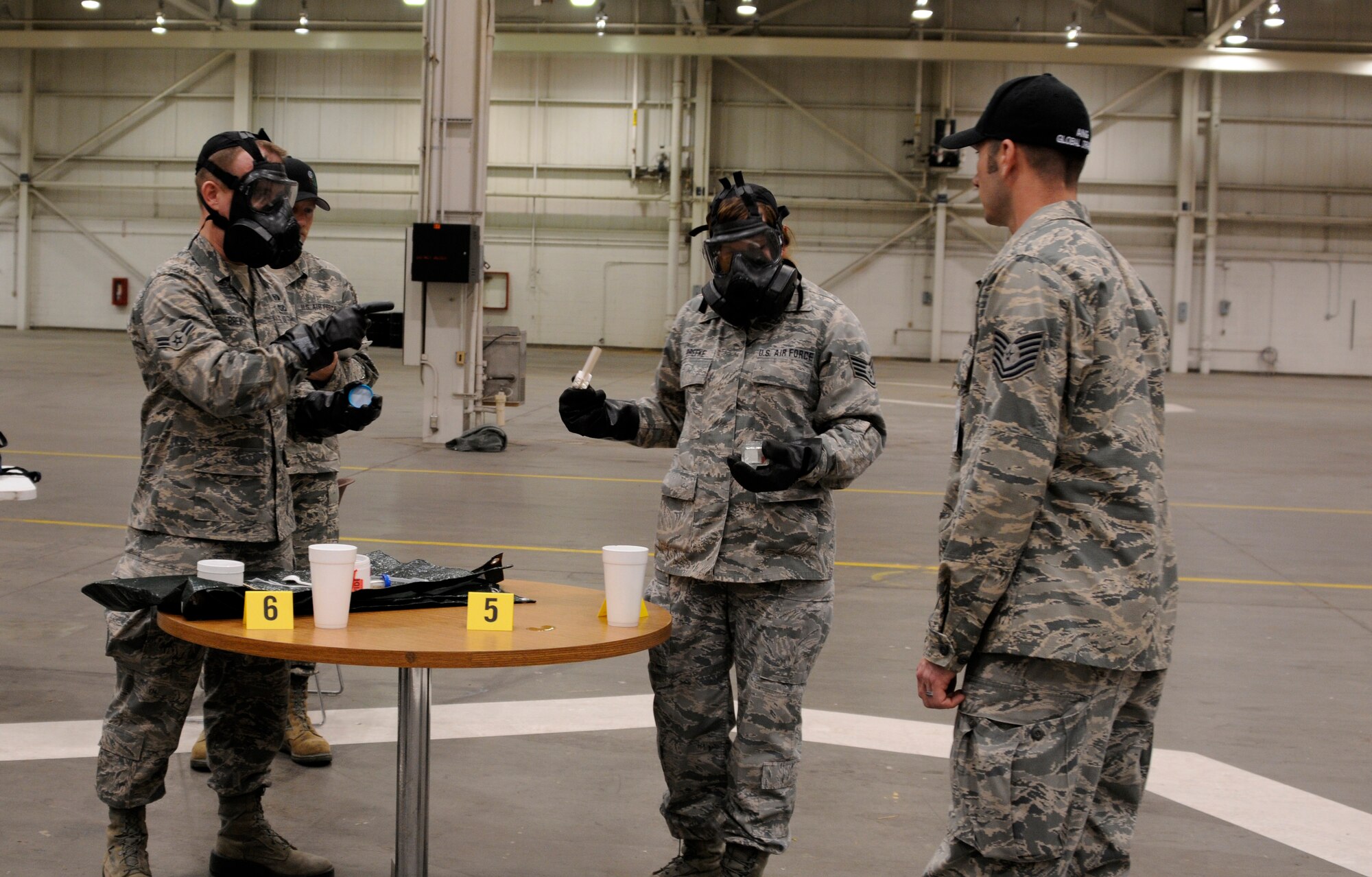 From left, Airman 1st Class Greggorey Brewer and Staff Sgt. Abby Drefke receive instructions from Tech. Sgt. David Palmer as they test a sample of an unidentified substance during Global Dragon deployment for training at the Guardian Centers of Georgia, Perry, Ga., March 10, 2015. The sample testing is one of the final refresher courses the Airmen will have before they utilize their skills to identify live chemical agents and hazardous material in future training days. Air National Guard emergency management technicians from all 10 Federal Emergency Management Agencies participated in Global Dragon. Brewer is assigned to the 188th Wing, Ark., Drefke is assigned to the 185th Air Refueling Wing, Iowa and Palmer a Global Dragon cadre assigned to the 138th Fighter Wing, Okla. (U.S. National Guard photo by Staff Sgt. Hannah Dickerson/released)