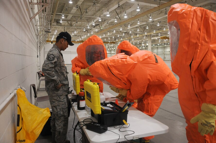 Master Sgt. Robby McGee, Global Dragon cadre assigned to the 188th Wing, assists members of the Air National Guard with the use of the hazardous material identification command system during the Global Dragon deployment for training at the Guardian Center, Perry, Ga., March 9, 2015. The HAZMAT ID command system uses reflections of light to identify materials. (U.S. Air National Guard photo by Senior Airman Cody Martin/released)