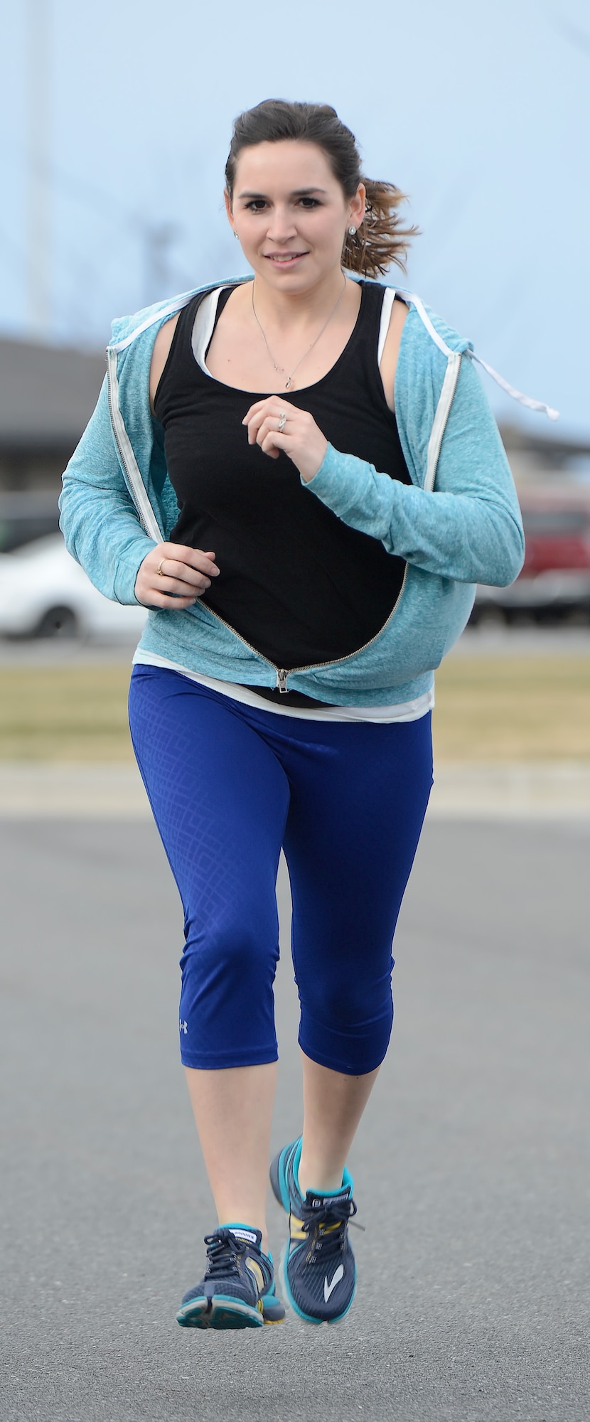 Mallory Diehl, wife of Tech. Sgt. Chad Diehl, 436th Civil Engineer Squadron firefighter,  extends her stride while running March 31, 2015, on Dover Air Force Base, Del. Mallory set goals for herself during her husbands??? recent deployment by training for and running at least one road-race a month during his six-month deployment. Upon his return, the couple completed a half-marathon together. (U.S. Air Force photo/Greg L. Davis)