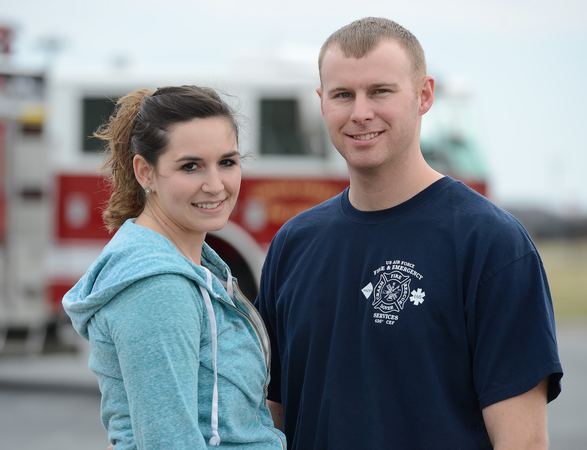 Mallory and Tech. Sgt. Chad Diehl, 436th Civil Engineer Squadron firefighter, pose together at the main fire station March 31, 2015, on Dover Air Force Base, Del.  The couple dealt with deployment stress by running monthly road-races. (U.S. Air Force photo/Greg L. Davis)