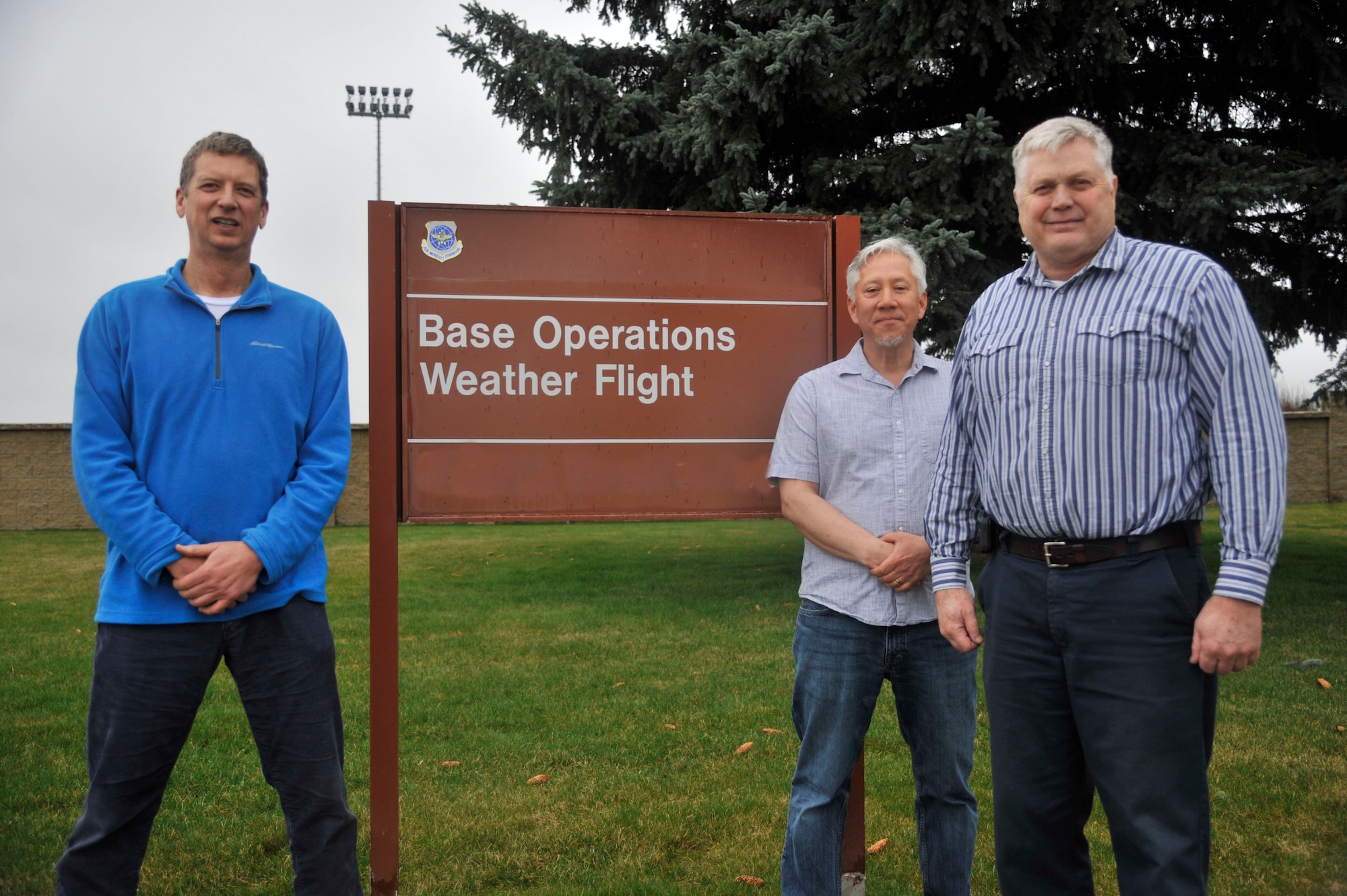 Timothy Scheidt, a 92nd Operations Support Squadron weather forecaster, Glen Forward, a 92nd OSS flight planner, and Ralph Homan, a 92nd OSS software support representative, pose for a photo March 25, 2015, at Fairchild Air Force Base, Wash. The three men have worked together for the last 13 years and have learned that without each other it would be nearly impossible to get the mission done. (U.S. Air Force photo/Airman 1st Class Taylor Bourgeous)
