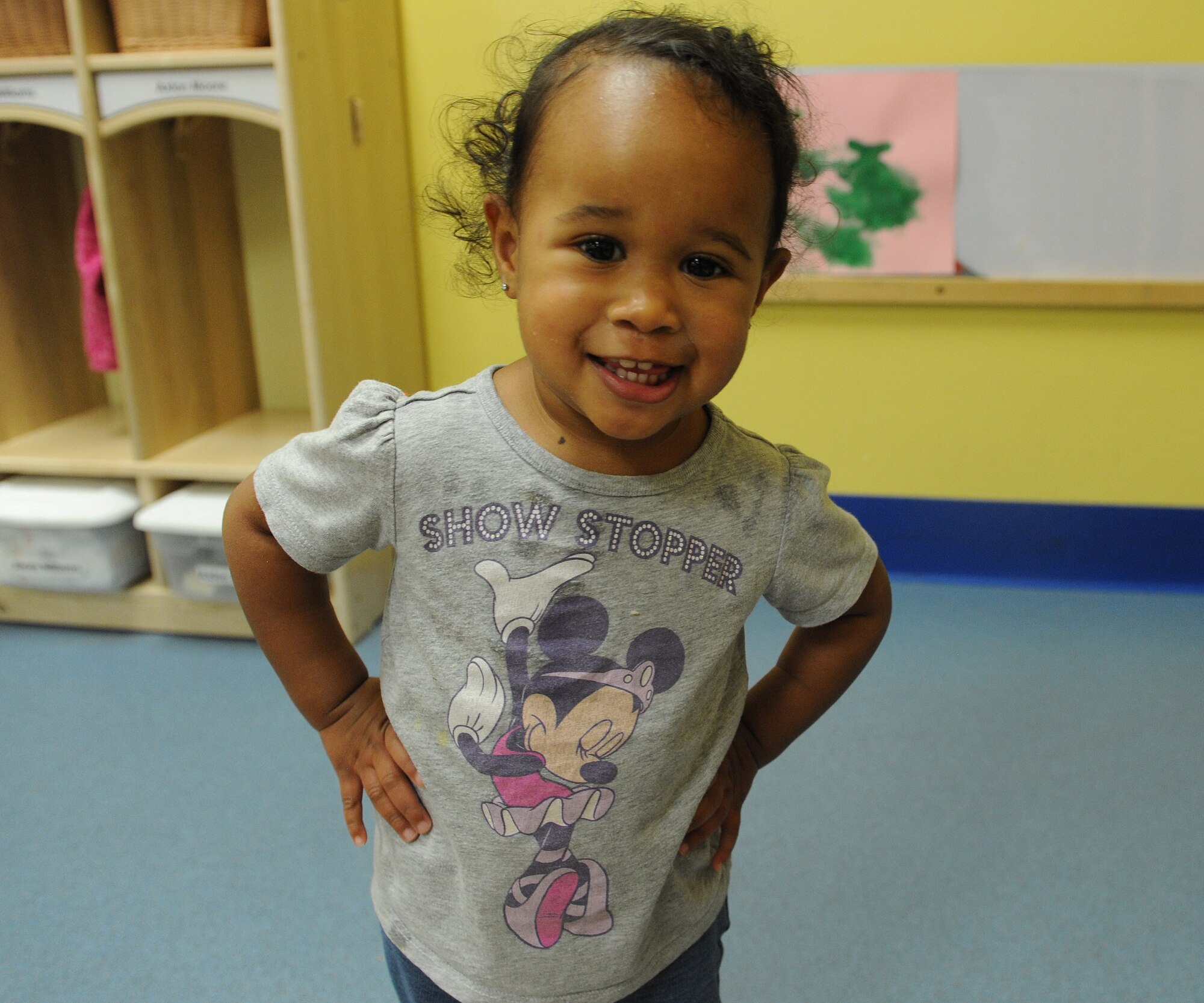 Alexis Williams, daughter of Staff Sgt. Maryanne Williams, 85th Engineering Installation Squadron information technology NCO in charge, poses for a photo March 3, 2015, at the Keesler Child Development Center, Keesler Air Force Base, Miss. The CDC uses hands-on learning techniques to help children ranging from 6 weeks to 5 years old learn reading, speaking and comprehension skills. (U.S. Air Force photo by Senior Airman Holly Mansfield)