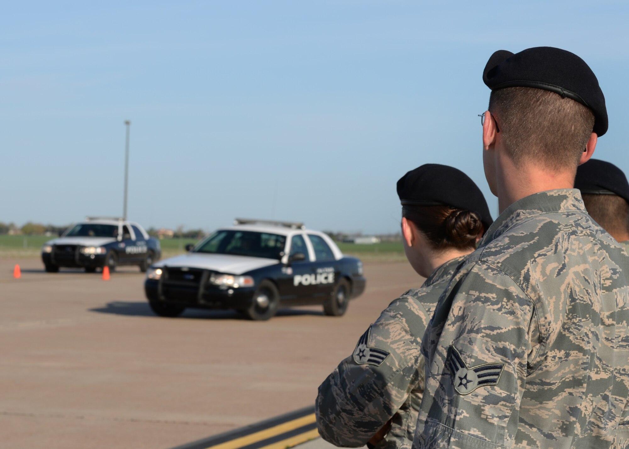 ALTUS AIR FORCE BASE, Okla. – Airmen from the 97th Security Forces Squadron watch as instructors from the Altus Police Department demonstrate driving techniques, April 4, 2015. Those who attended the three-day course learned proper ways of handling a vehicle at high speeds and techniques on making tight turns. (U.S. Air Force photo by Airman 1st Class Nathan Clark/Released)