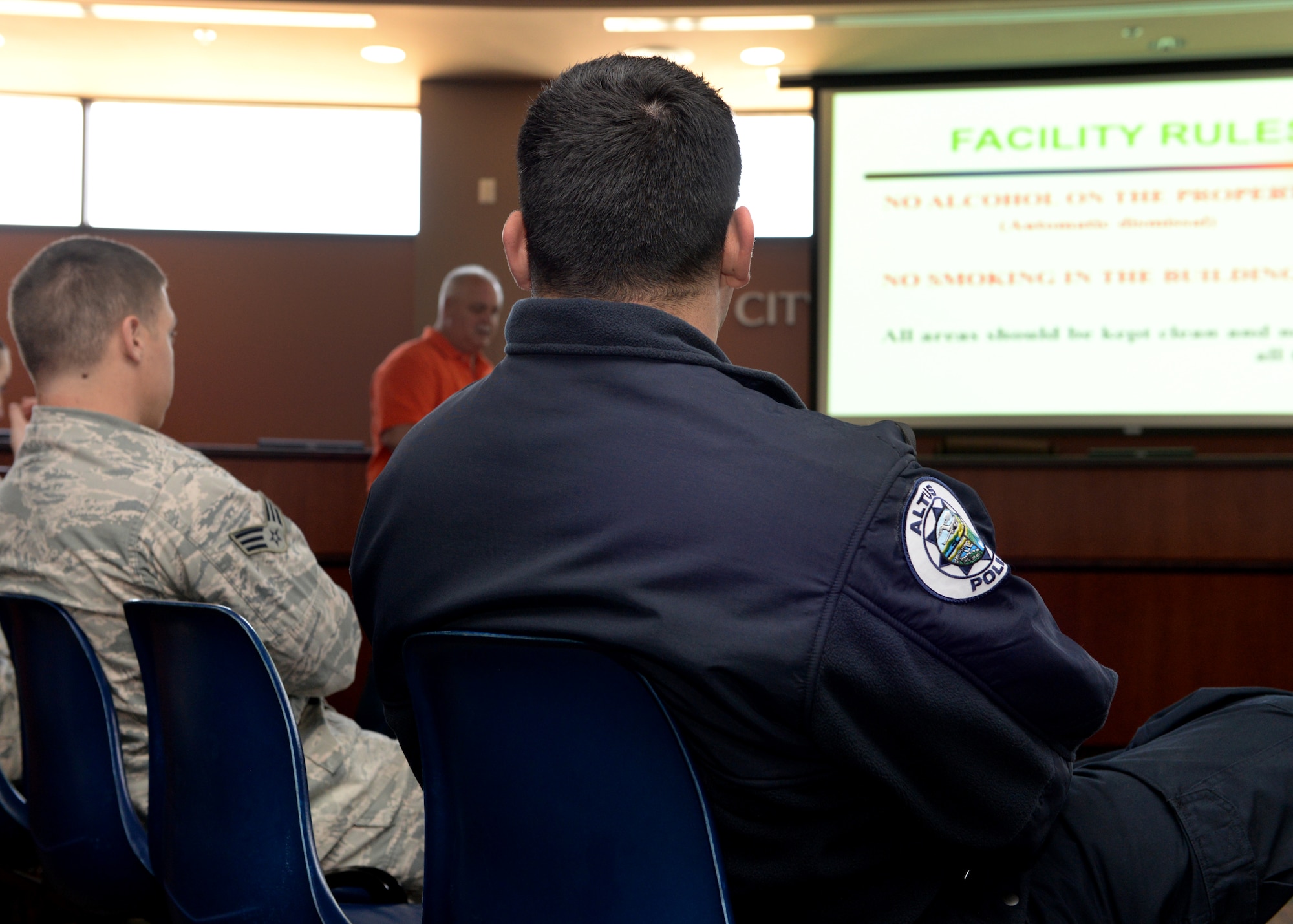 ALTUS AIR FORCE BASE, Okla. – U.S. Airmen and Altus Police officers listen as the rules for a driving course are explained, before maneuverability training, at the Altus Police Department, April 3, 2015. The Altus Police Department and the 97th Security Forces Squadron began a new tactical driving course on base to teach Security Forces Airmen and Altus Police Department officers how to safely maneuver patrol vehicles at high speeds. (U.S. Air Force photo by Airman 1st Class Nathan Clark/Released)