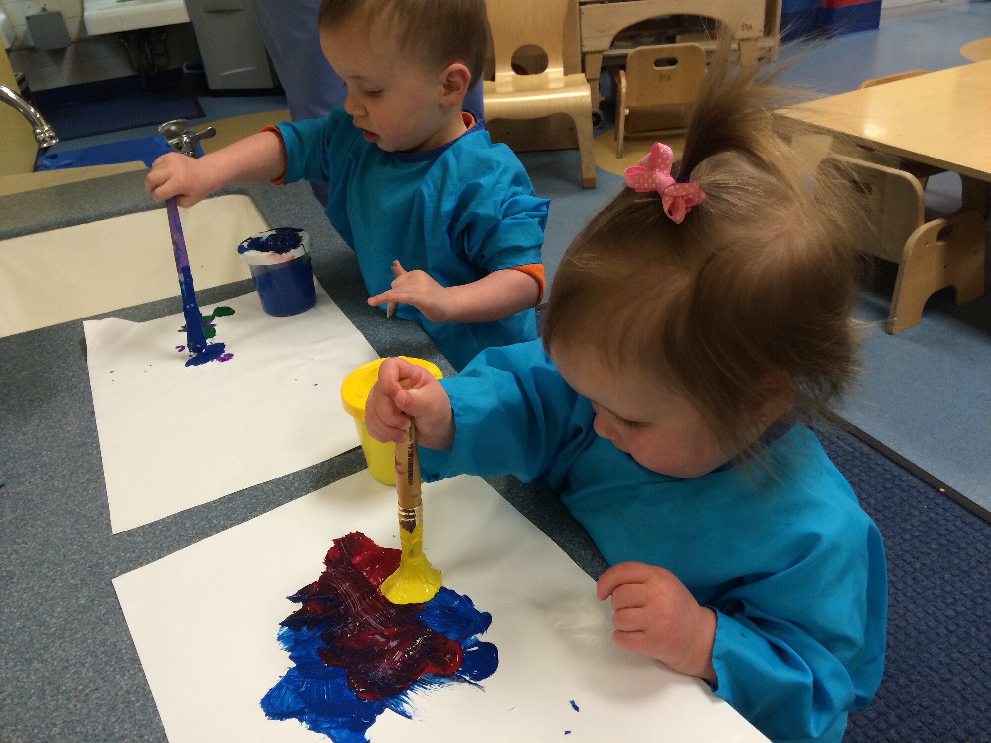 Landon Bellio, son of Staff Sgt. Jonathan Bellio, 338th Training Squadron instructor, and Abbey Mansfield, daughter of Senior Airman William Mansfield, 81st Logistics Readiness Squadron, paint pictures March 5, 2015, at the Keesler Child Development Center, Keesler Air Force Base, Miss. The CDC uses hands-on learning techniques to help children ranging from 6weeks to 5 years old learn reading, speaking and comprehension skills. (U.S. Air Force photo by Senior Airman Holly Mansfield)