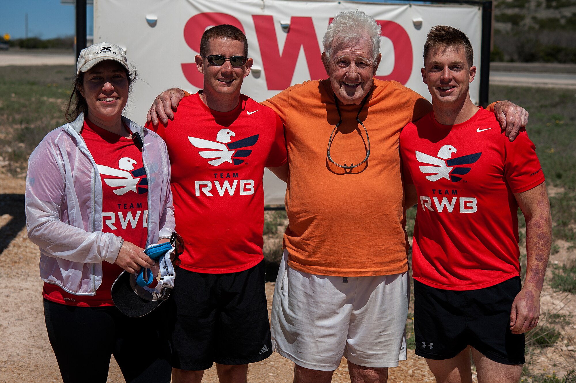 STERLING CITY, Texas -- Ernie Andrus, Navy World War II veteran, poses for a photo with Team Red White and Blue members March 26. Team RWB accompanied Andrus in his 7.11 mile run through Sterling City. (U.S. Air force photo/ Airman 1st Class Devin Boyer)