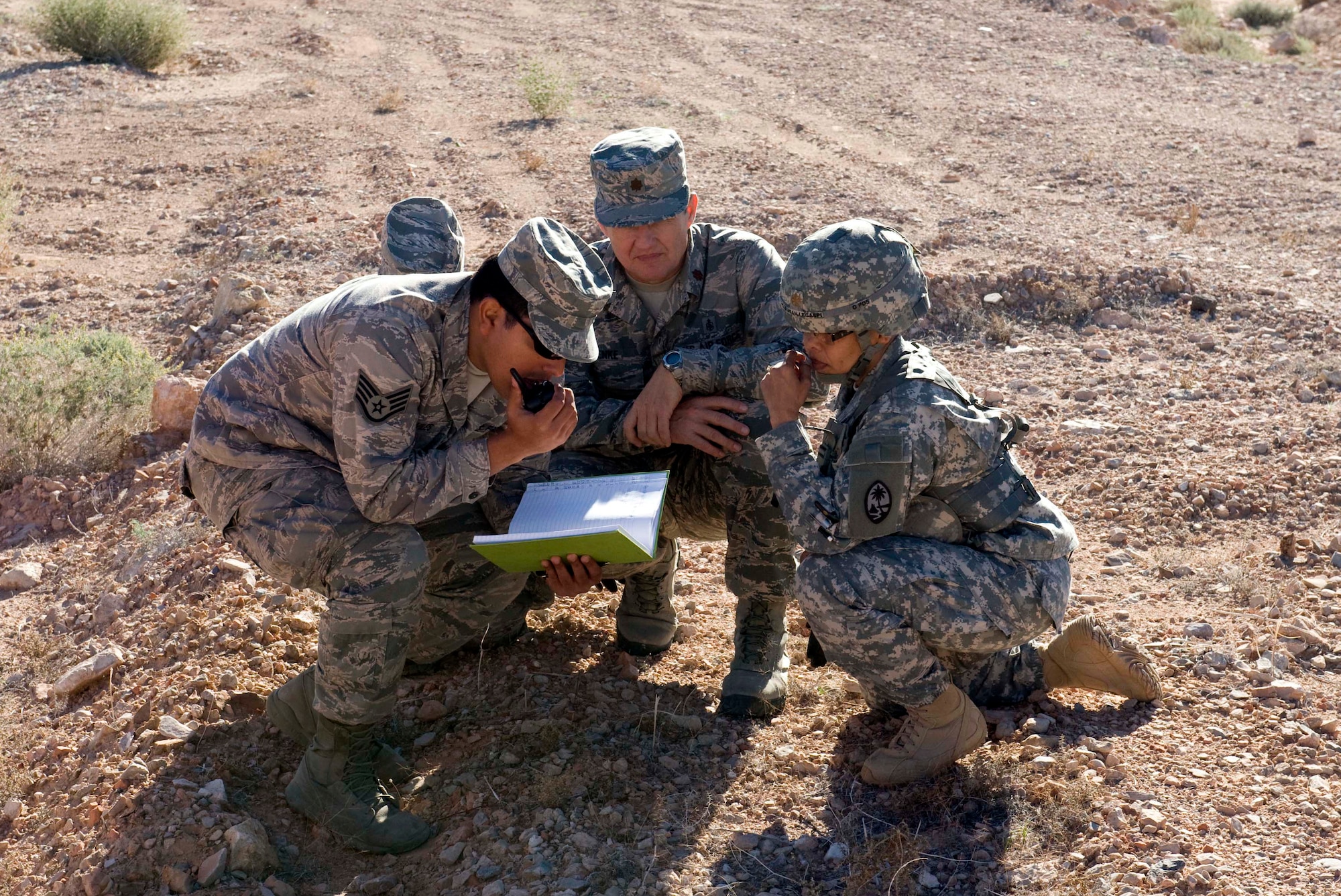 Participants in Operation Joint Medic relay information through a radio at Nellis Air Force Base, Nev., March 27, 2015. The exercise included members from the 926th Aerospace Medicine Squadron, 624th Aeromedical Staging Squadron, Joint Base Pearl Harbor-Hickam, Hawaii, Guam Army National Guard medical detachment, and the 66th Rescue Squadron. (U.S. Air Force photo by Airman 1st Class Rachel Loftis)     