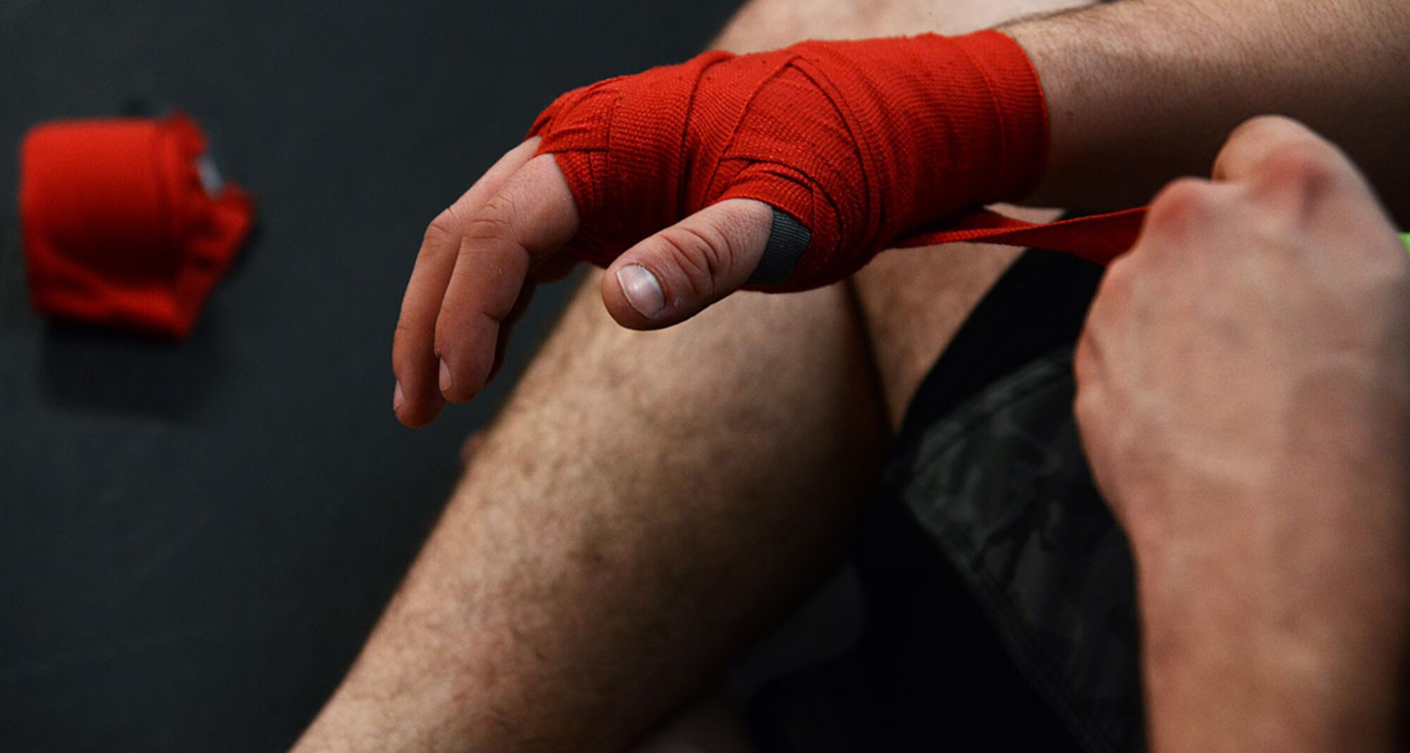 Senior Airman Zack Throckmorton, an F-22 Raptor weapons systems loader with the 3rd Aircraft Maintenance Squadron, 525th Aircraft Maintenance Unit, wraps his hands to prevent any direct injuries to his knuckles while striking at Martial Arts Alaska, in Anchorage, Alaska on March 27, 2015. Safety is important in training and especially during a fight, which is why the trainees all wear wraps and cups during practice. (Air Force photo/Airman Christopher R. Morales