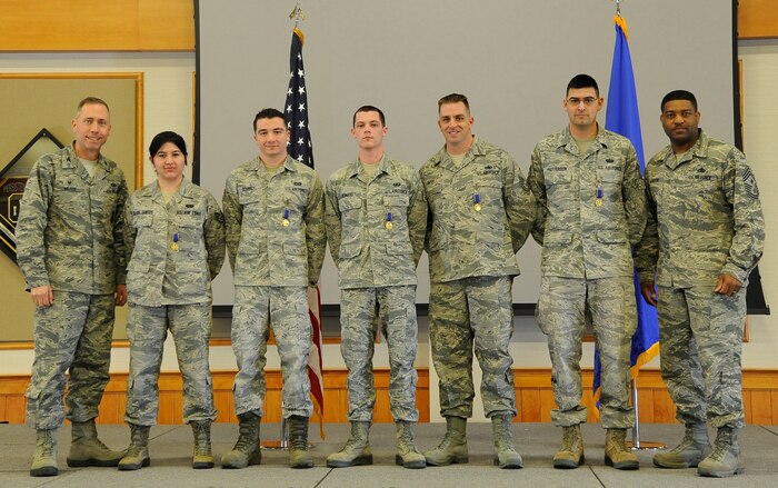 Col. Tom Wilcox, 341st Missile Wing commander (left) and Chief Master Sgt. Phillip Easton, 341st MW command chief (right) stand with five Airmen that received the Nuclear Deterrence Operations Service Medal during a commander’s call April 2 at the Grizzly Bend, Malmstrom Air Force Base, Mont. Wilcox said that the presentation of these medals to Airmen demonstrates the importance of awarding the medals earned for direct support of nuclear deterrence operations.  (U.S. Air Force photo/Staff Sgt. Delia Marchick)