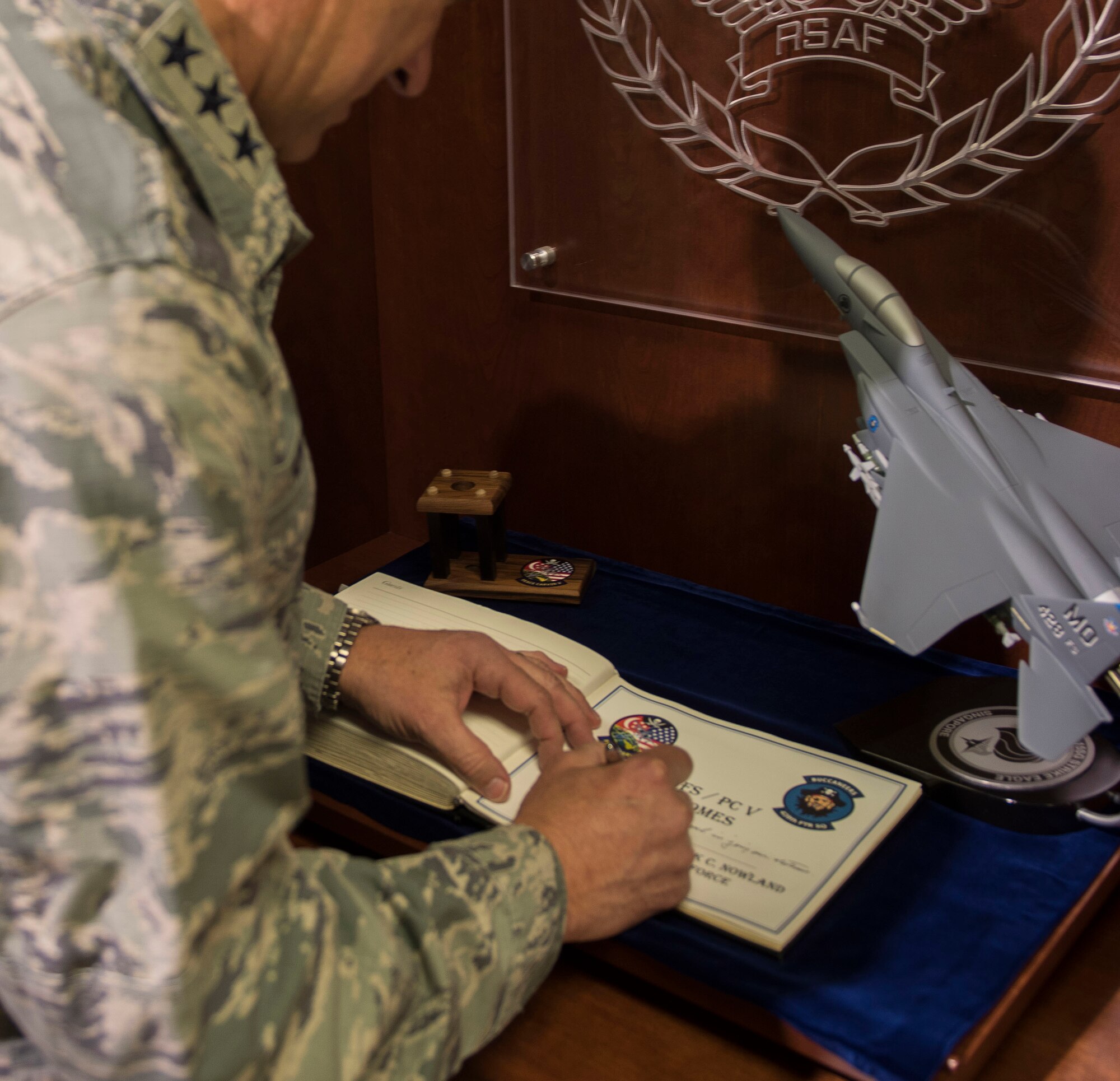 Lt. Gen. Chris Nowland, 12th Air Force (Air Forces Southern) commander, signs the distinguished visitor guestbook at the 428th Fighter Squadron at Mountain Home Air Force Base, Idaho, April 1, 2015. Legacy and heritage are important to American fighter squadrons, a culture shared with Singaporean airmen in the 428th FS. (U.S. Air Force photo by Airman Connor J. Marth/RELEASED)