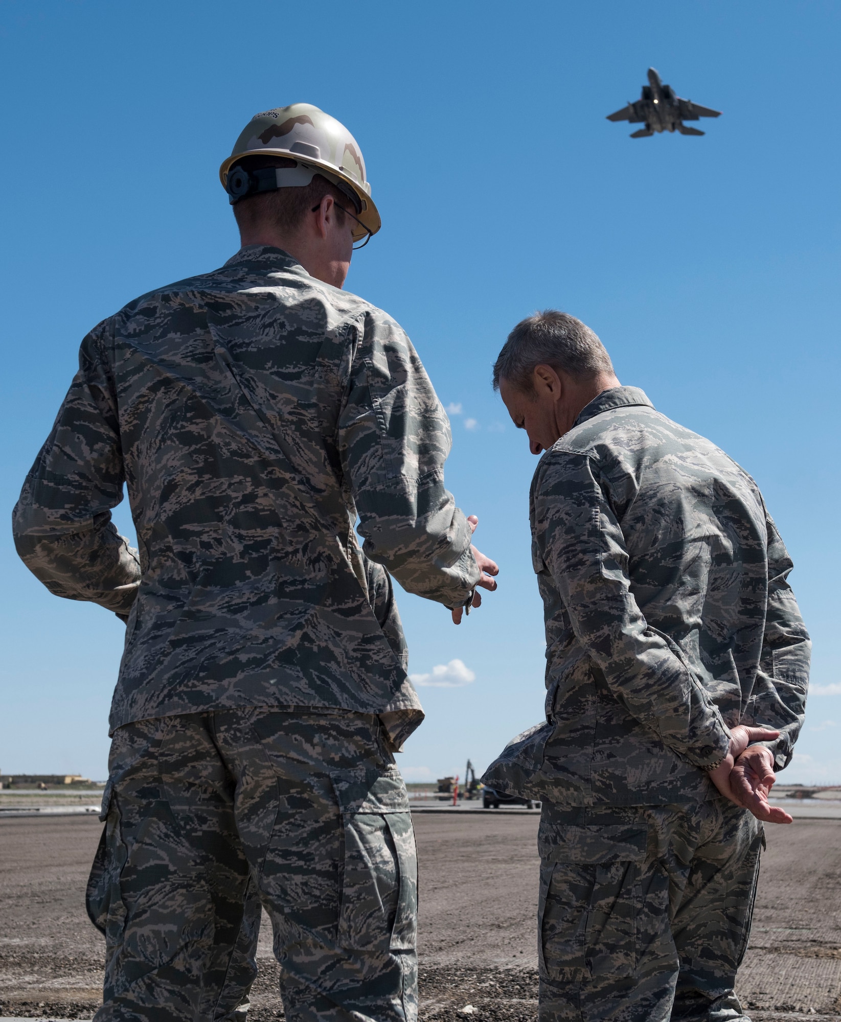 Lt. Gen. Chris Nowland (right), 12th Air Force (Air Forces Southern) commander, discusses the future of a runway reconstruction project with 2nd Lt. Jared Breuker, 366th Civil Engineering Squadron airfield construction manager, at Mountain Home Air Force Base, Idaho, April 1, 2015. The 13,508-foot runway is scheduled to undergo a three-phase reconstruction process. (U.S. Air Force photo by Airman 1st Class Jeremy L. Mosier/RELEASED)