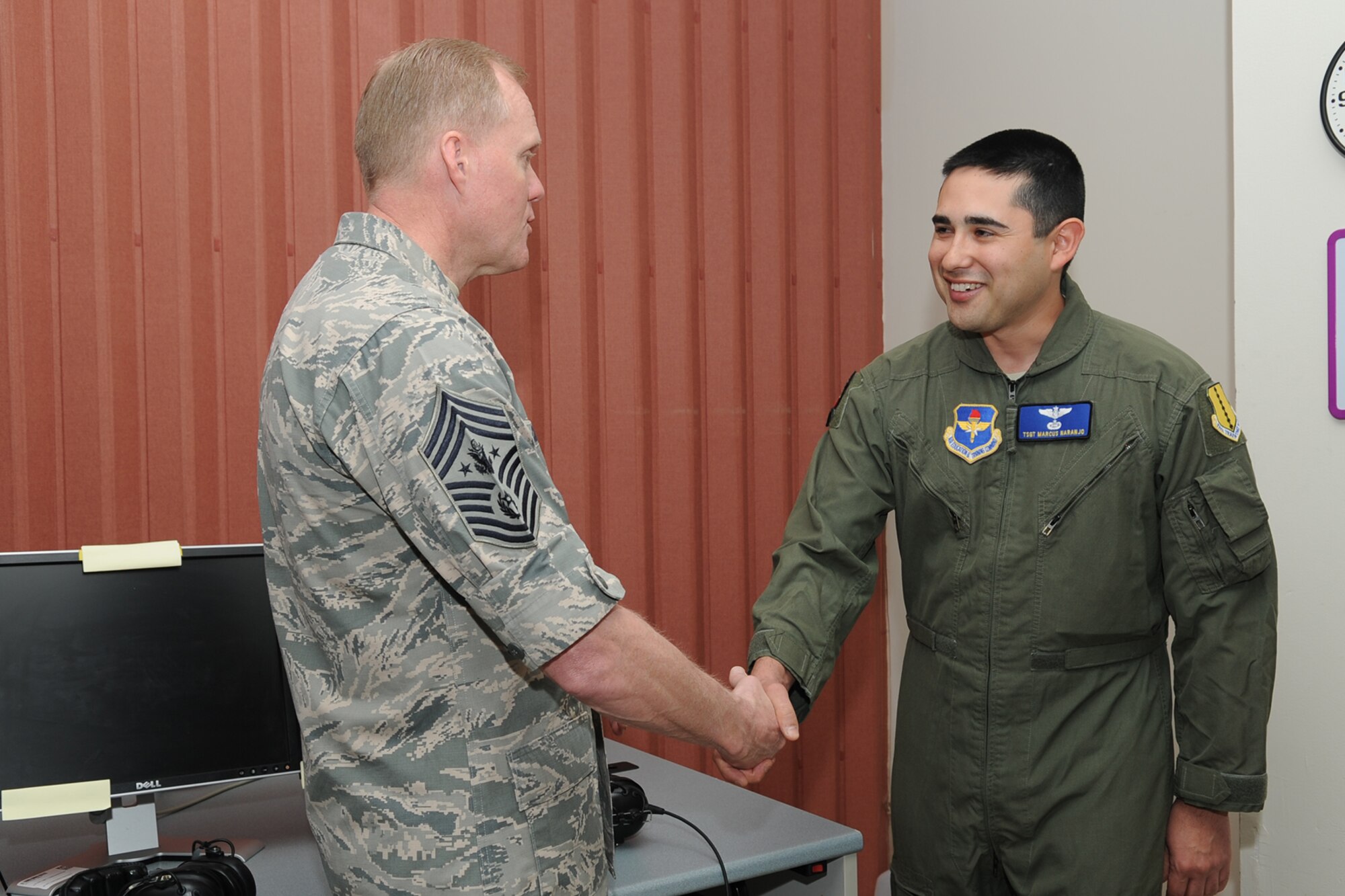 GOODFELLOW AIR FORCE BASE, Texas – Chief Master Sgt. of the Air Force James Cody coins Tech. Sgt. Marcus A. Naranjo, 316th Training Squadron instructor, during Cody’s visit to the 17th Training Wing April 3. Cody visited the 17th TRW to visit with Airmen and discuss topics affecting the enlisted force. (U.S. Air Force photo/ Staff Sgt. Laura R. McFarlane)
