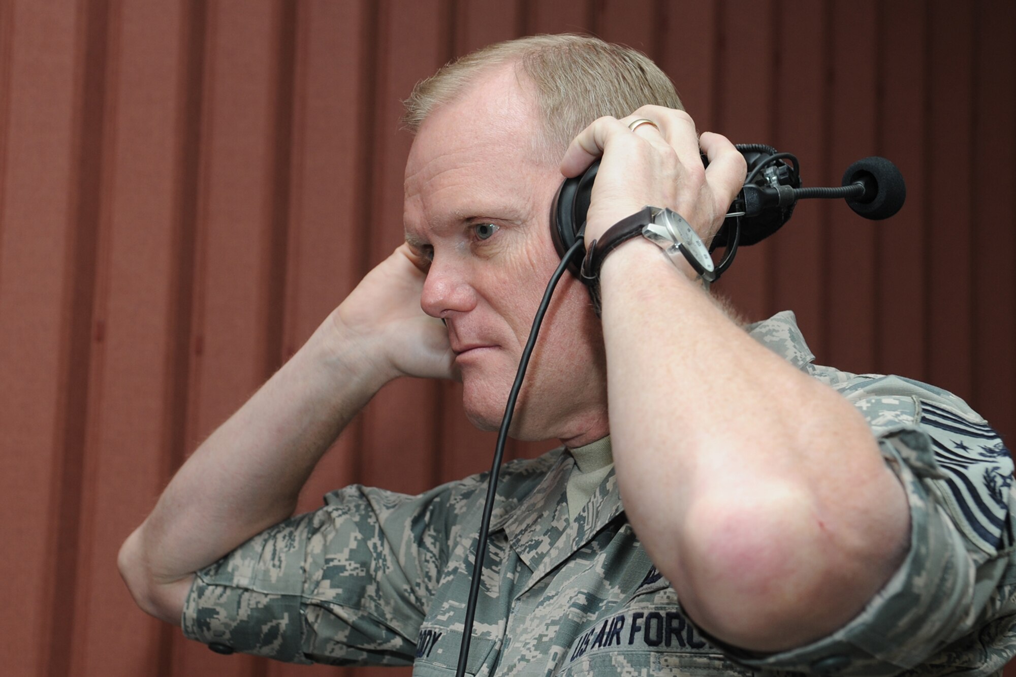 GOODFELLOW AIR FORCE BASE, Texas – Chief Master Sgt. of the Air Force James Cody, listens to a sample of the course material 316th Training Squadron students use during his visit to the 17th Training Wing April 3. Cody previously visited Goodfellow in 2011 when he was the Air Education and Training Command, Command Chief. (U.S. Air Force photo/ Staff Sgt. Laura R. McFarlane)