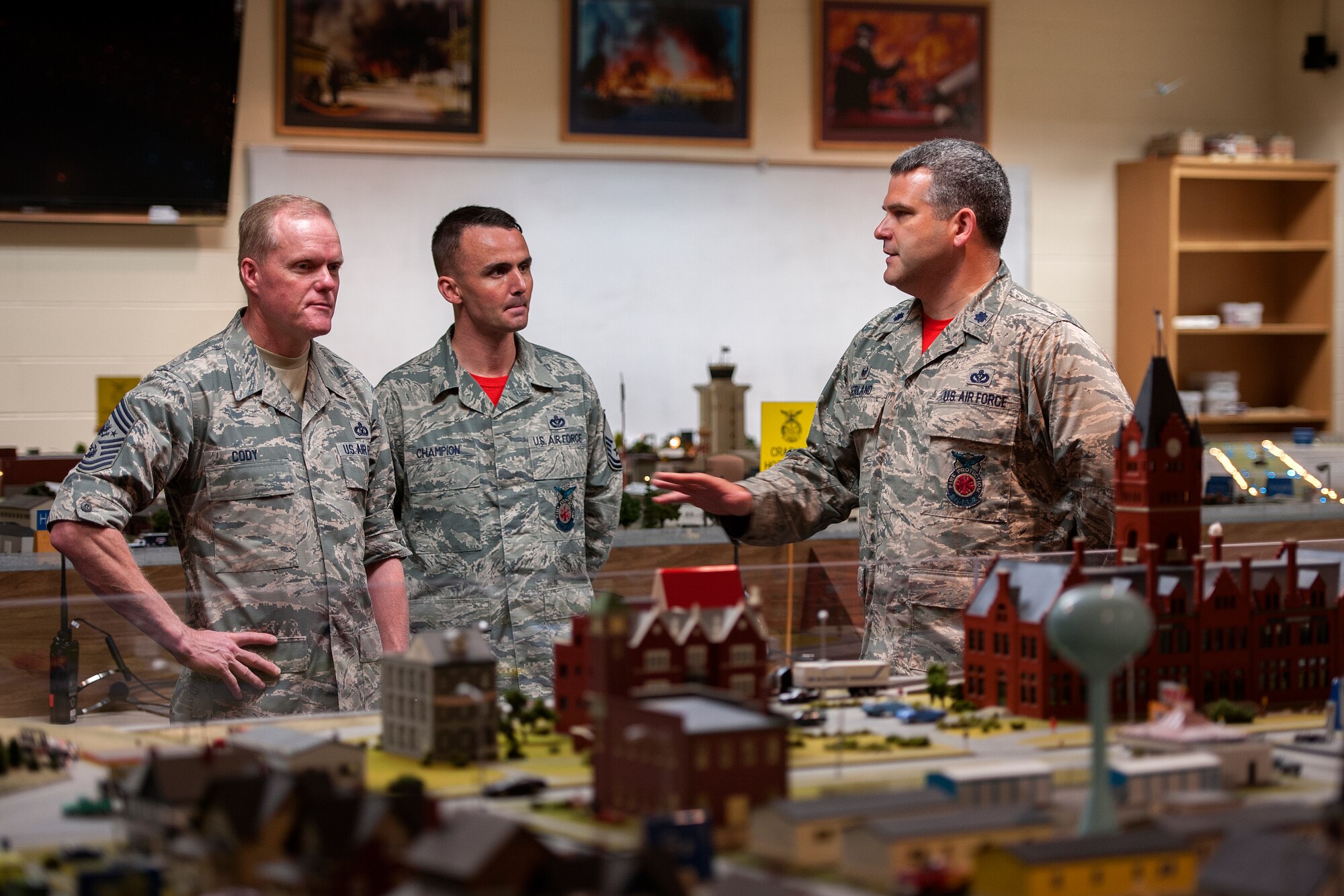 GOODFELLOW AIR FORCE BASE, Texas – Lt. Col. Derek R. Ferland, 312th Training Squadron Commander, right, and Master Sgt. Michael D. Champion, 312th TRS Fire Officer Courses NCOIC, center, speak with Chief Master Sgt. of the Air Force James Cody, left, at the Louis F. Garland Department of Defense Fire Academy April 3. Ferland explained how the Command and Control Simulations Trainer, a scale model of a city, enhances command and control training for fire protection professionals. (U.S. Air Force photo/ Airman 1st Class Devin Boyer)