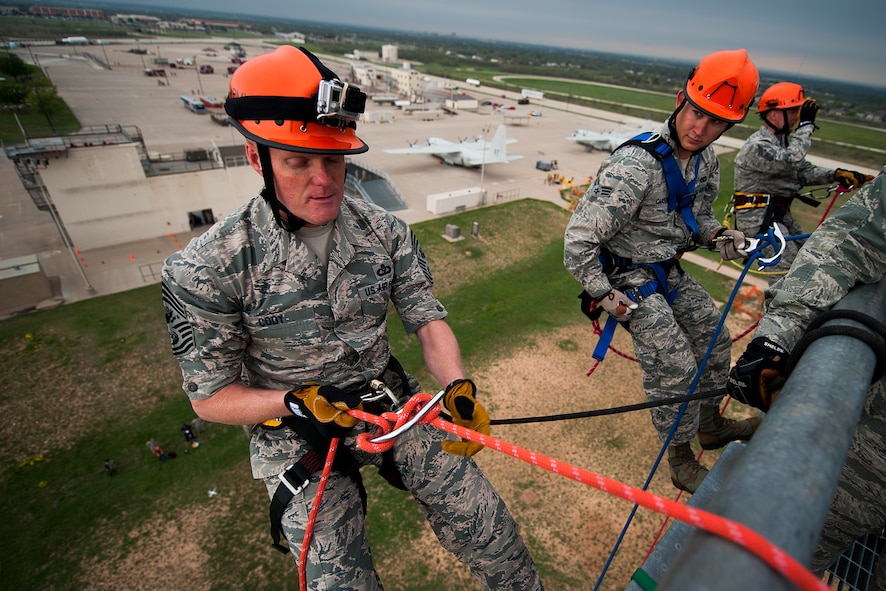 GOODFELLOW AIR FORCE BASE, Texas – Chief Master Sgt. of the Air Force James Cody, left, prepares to rappel down a 90-foot tower with Senior Airman Cody Carson, 312th Training Squadron firefighting student, center, and Chief Master Sgt. Thomas F. Good, 17th Training Wing Command Chief, right, at the Louis F. Garland Department of Defense Fire Academy April 3. Cody toured the fire academy and observed different aspects of fire protection training while visiting with staff and students. (U.S. Air Force photo/ Airman 1st Class Devin Boyer)