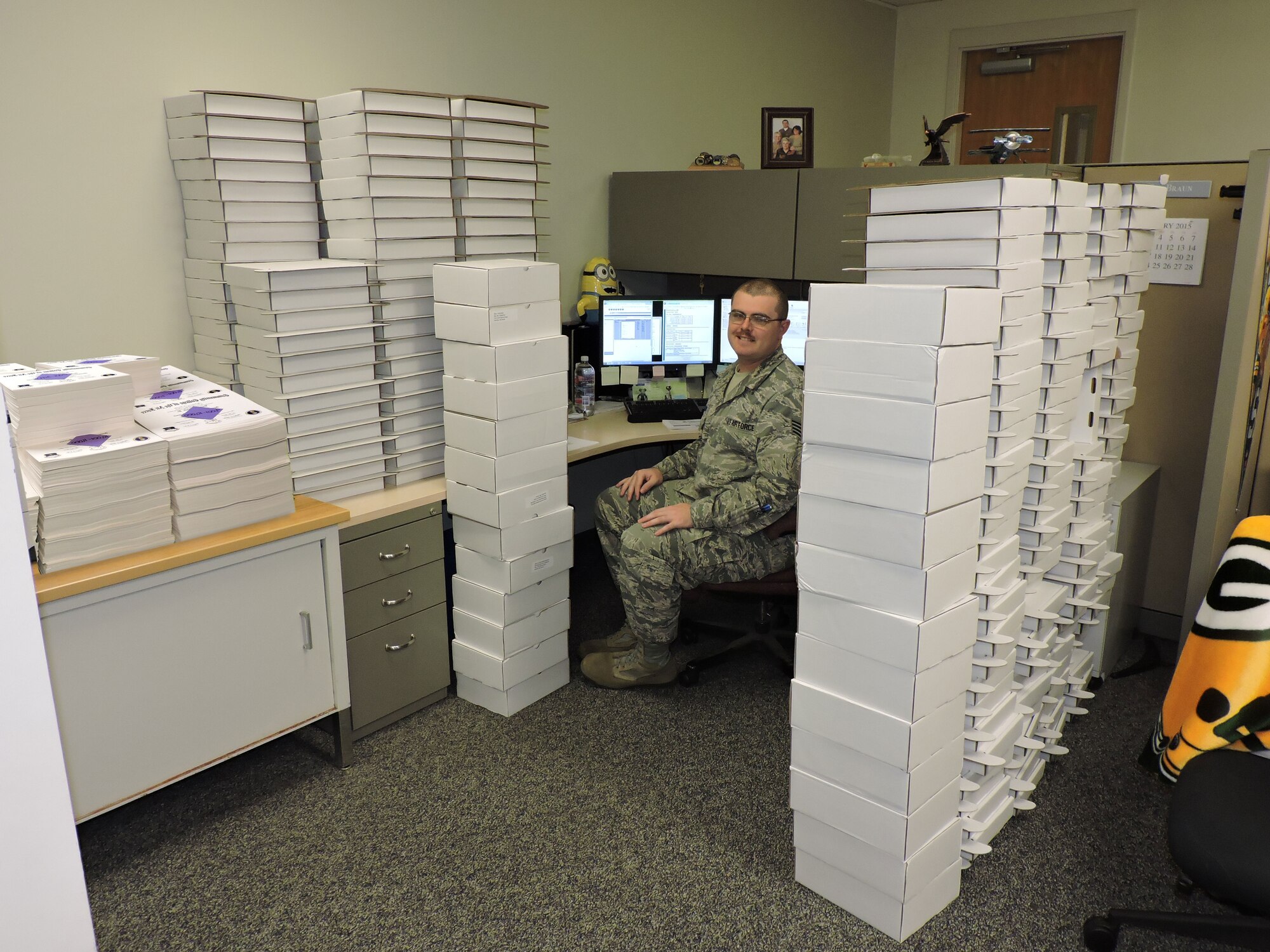 Staff Sgt. Marlin Braun, CCAF student services technician, sits with the boxes containing the 11,575 associate degree diplomas March 31, 2015, representing the largest spring graduating class ever for CCAF. (Courtesy photo)