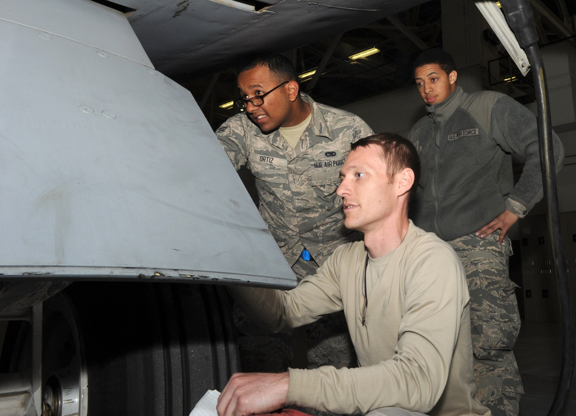 Airman 1st Class Jose Ortiz, left, Senior Airman Bryant Standridge, center, and Airman 1st Class Brandon Roby, 22nd Aircraft Maintenance Squadron crew chiefs, perform a high-winds inspection on a KC-135 Stratotanker, April 3, 2015 at McConnell Air Force Base, Kan. During high-winds inspections, crew chiefs look for any dents or cracks caused by high wind speeds that may compromise the integrity of the aircraft. (U.S. Air Force photo by Airman 1st Class Tara Fadenrecht)