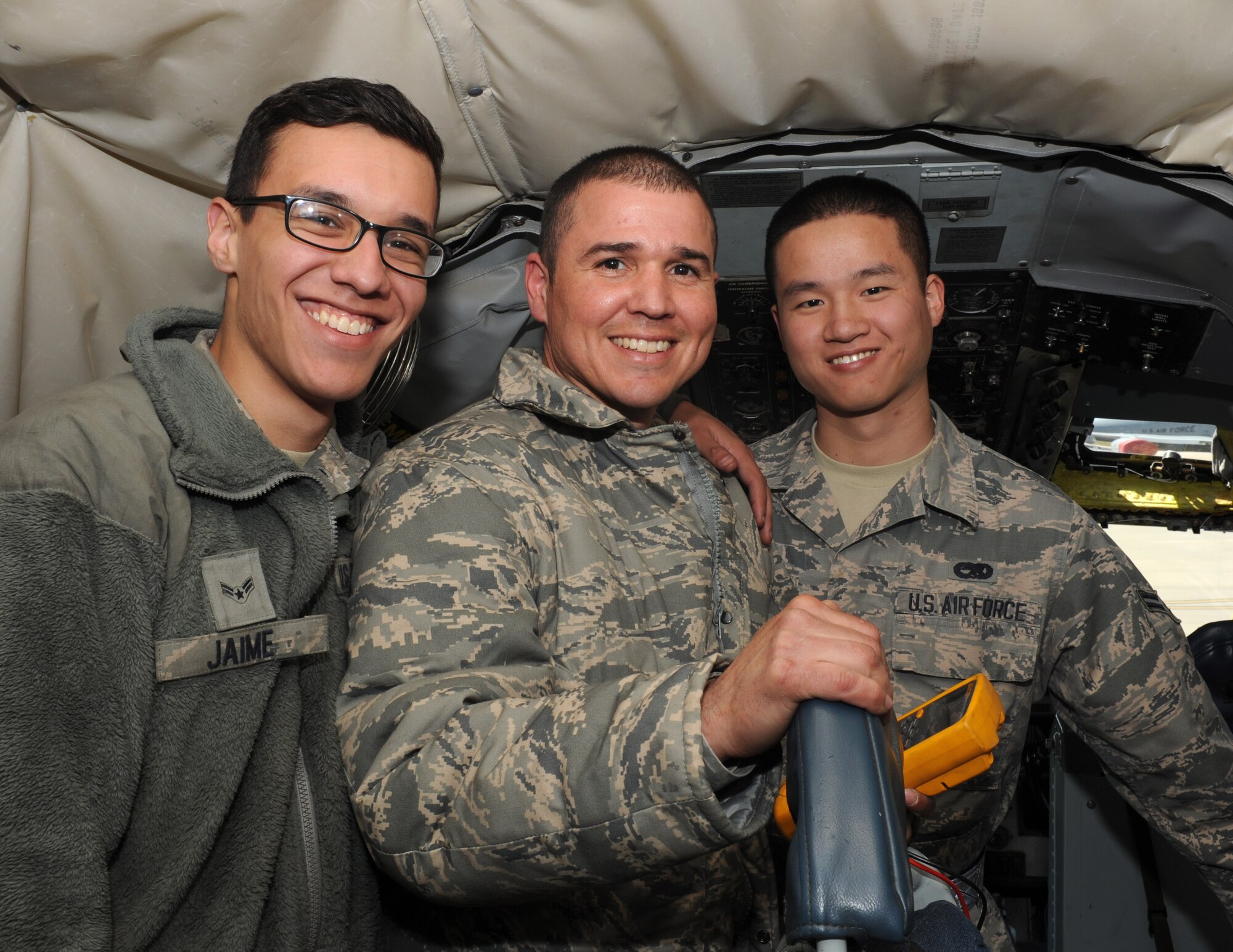 Airman 1st Class Kahn Jaime, left, Tech. Sgt. Braulio Coriano, center, and Airman 1st Class Dawei Yang, 22nd Aircraft Maintenance Squadron Airmen pose for a photo, April 3, 2015, at McConnell Air Force Base, Kan. The 22nd AMXS is an example of the diversity that can be seen throughout the Air Force. (U.S. Air Force photo by Airman 1st Class Tara Fadenrecht)