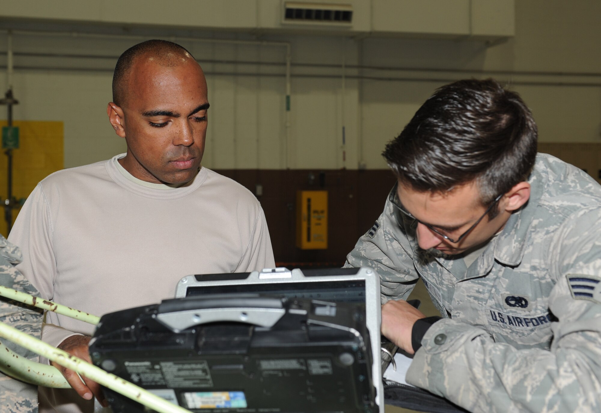 Tech. Sgt. Roberto Rodriguez, left, and Senior Airman Christopher Morgan, 22nd Aircraft Maintenance Squadron aerospace propulsion technicians, document information gathered during a high-winds inspection on a KC-135 Stratotanker, April 3, 2015, at McConnell Air Force Base, Kan. These inspections are performed after aircraft are exposed to unusually high-speed winds. (U.S. Air Force photo by Airman 1st Class Tara Fadenrecht)