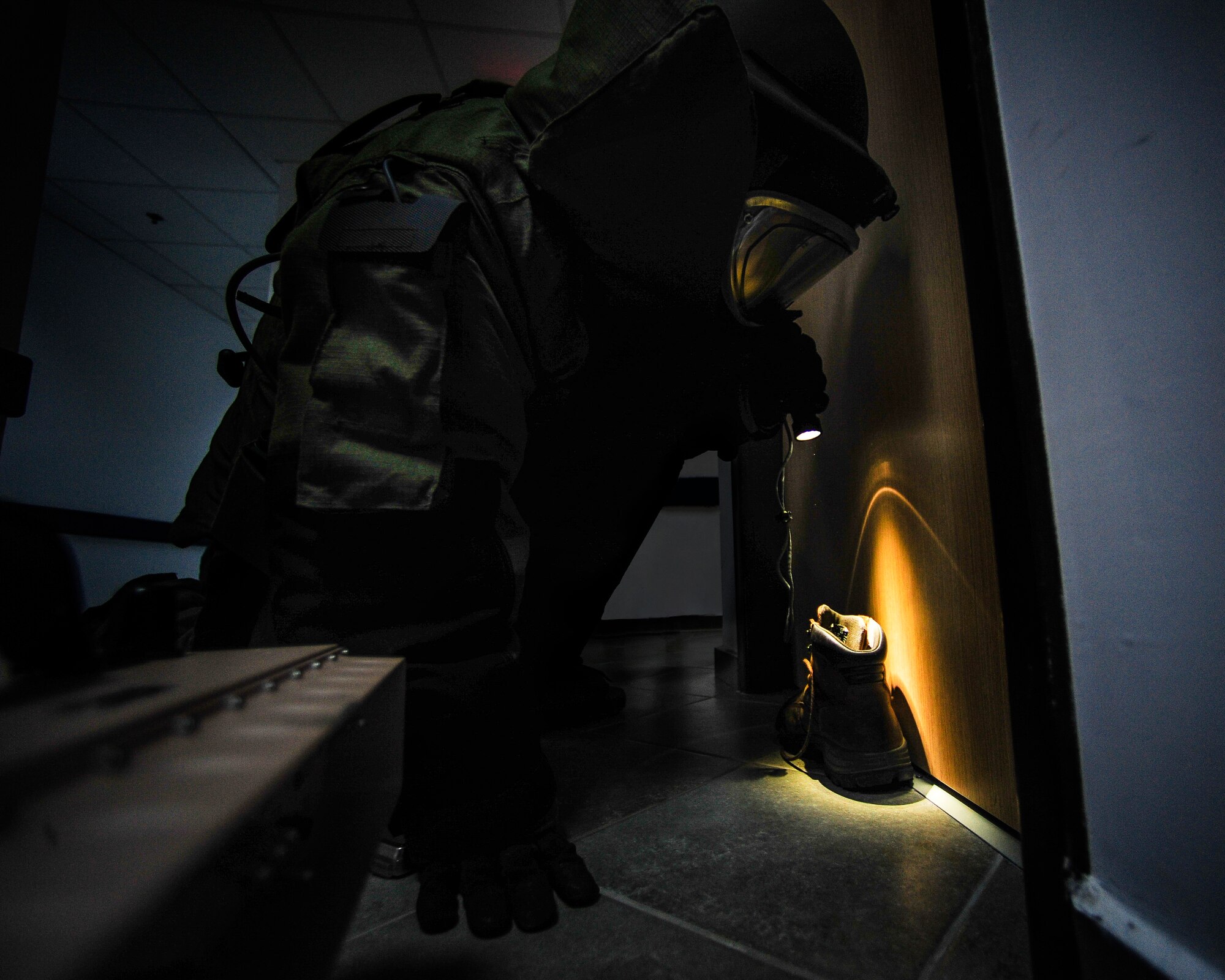 Staff Sgt. Alexander Blair, 39th Civil Engineer Explosive Ordinance Disposal journeyman, searches the shoe of an active shooter for an explosive device during an active shooter exercise March 30, 2015, at Incirlik Air Base, Turkey. The 39th Air Base Wing Inspector General Team observed the exercise to assess first responder’s abilities in case of a real-world emergency. (U.S. Air Force photo by Airman 1st Class Cory W. Bush/Released)