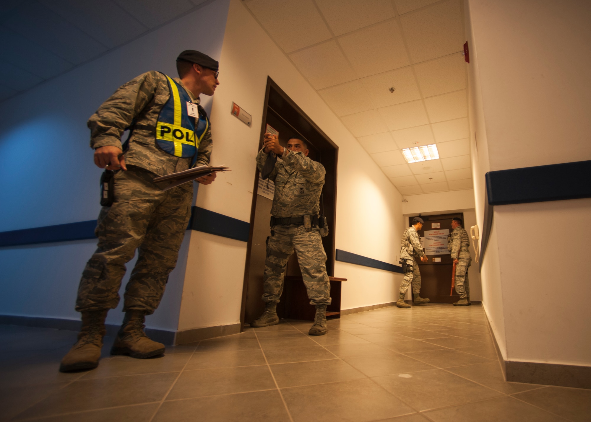 Tech Sgt. Esequiel Munguia, Staff Sgt. James Hartnett and Staff Sgt. Bryant Guillermo, 39th Security Forces Squadron patrolmen, are observed by a Wing Inspection Team member during an active shooter exercise March 30, 2015, at Incirlik Air Base, Turkey. First responders participated in the exercise to assess their readiness and effectiveness in case of a real-world emergency. (U.S. Air Force photo by Airman 1st Class Cory W. Bush/Released)