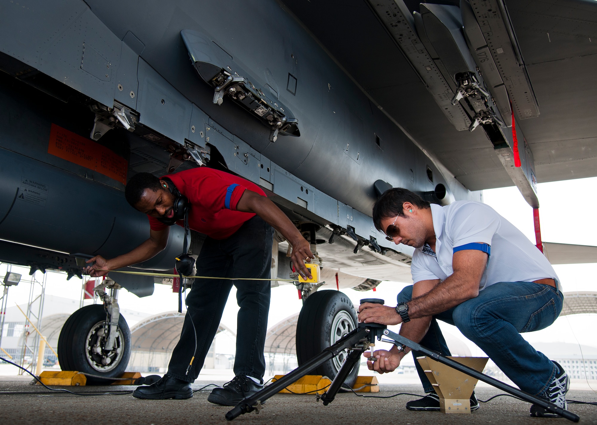 Samuel Burnham and Irvin Fontanes, Air Force Seek Eagle office, set up equipment for an electromagnetic interference and compatibility test of a LITENING pod on an F-15 Eagle March 18 at Eglin Air Force Base, Fla.  The test will measure the frequencies put out by the pod and ensure those transmissions do not interfere with the safe operation of the aircraft.  While the testing is performed on the ground, the aircraft is running with aircrew performing various flight procedures and reporting any interference.  This test is directly related to the AFSEO mission of ensuring new warfighter capabilities through the application and transfer of aircraft-store compatibility expertise.  (U.S. Air Force photo/Samuel King Jr.)