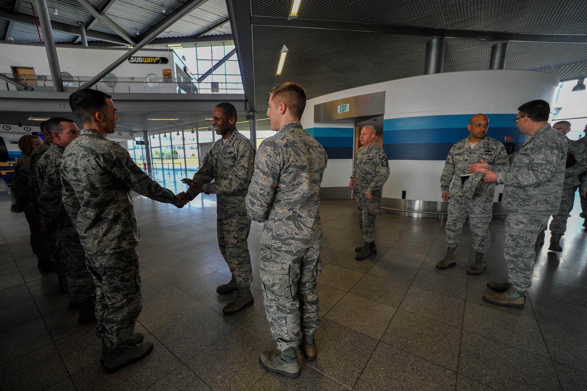 General Darren W. McDew, Air Mobility Command commander, greets Airmen from the 721st Aerial Port Squadron Ramstein Passenger Terminal at Ramstein Air Base, Germany,  March 30, 2015. During his visit to Ramstein, McDew had an opportunity to experience processing a customer through the passenger terminal in addition to touring the facility. (U.S. Air Force photo/Senior Airman Nicole Sikorski)