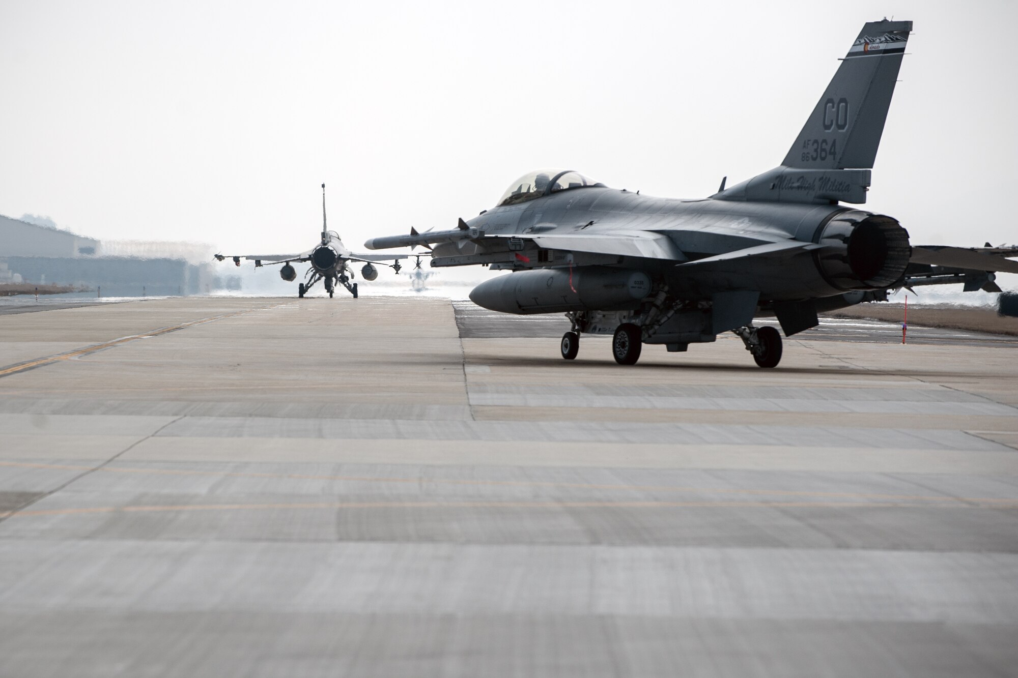 An F-16 Fighting Falcon from the 140th Wing, Colorado Air National Guard, taxis on the runway at Kunsan Air Base, Republic of Korea, March 6, 2015. The 140th jets along with more than 200 Airmen are temporarily stationed at Kunsan for three to four months as part of a rotational Theater Security Package. (U.S. Air Force photo by Senior Airman Taylor Curry/Released) 