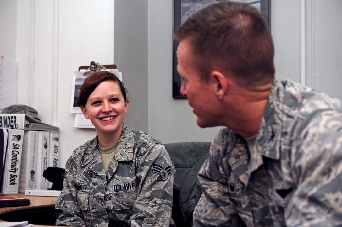 Senior Airman Sarah McDermott, 8th Logistics Readiness Squadron logistics planner, interacts with Col. Ken “Wolf” Ekman, 8th Fighter Wing commander, at Kunsan Air Base, Republic of Korea, March 25, 2015. McDermott showed Wolf how she contributes to the Wolf Pack mission. (U.S. Air Force photo by Senior Airman Taylor Curry/Released) 