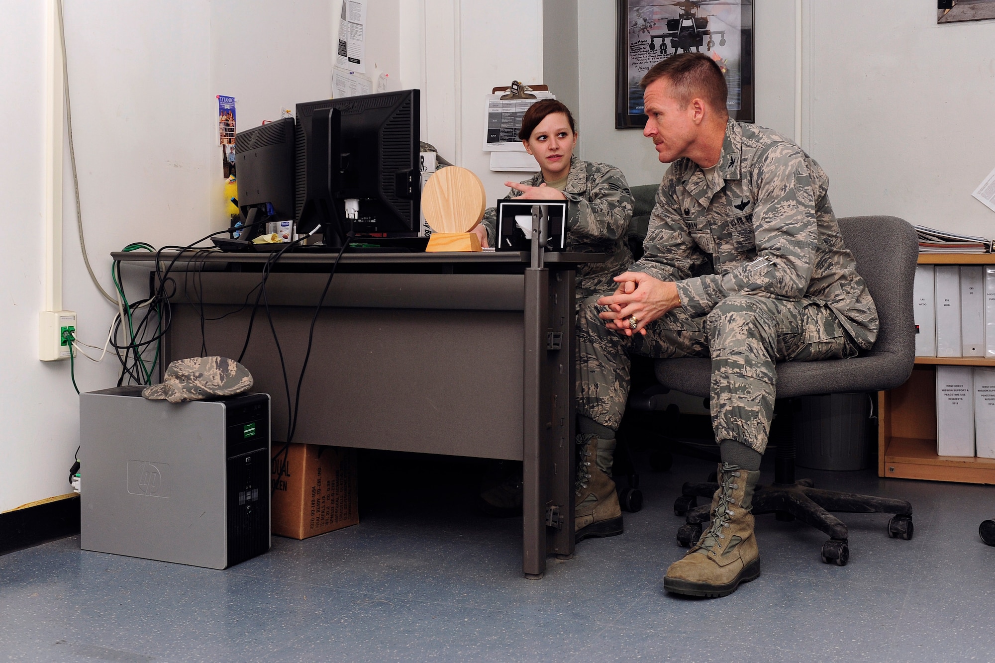 Senior Airman Sarah McDermott, 8th Logistics Readiness Squadron logistics planner, interacts with Col. Ken “Wolf” Ekman, 8th Fighter Wing commander, at Kunsan Air Base, Republic of Korea, March 25, 2015. McDermott showed Wolf how she contributes to the Wolf Pack mission. (U.S. Air Force photo by Senior Airman Taylor Curry/Released) 