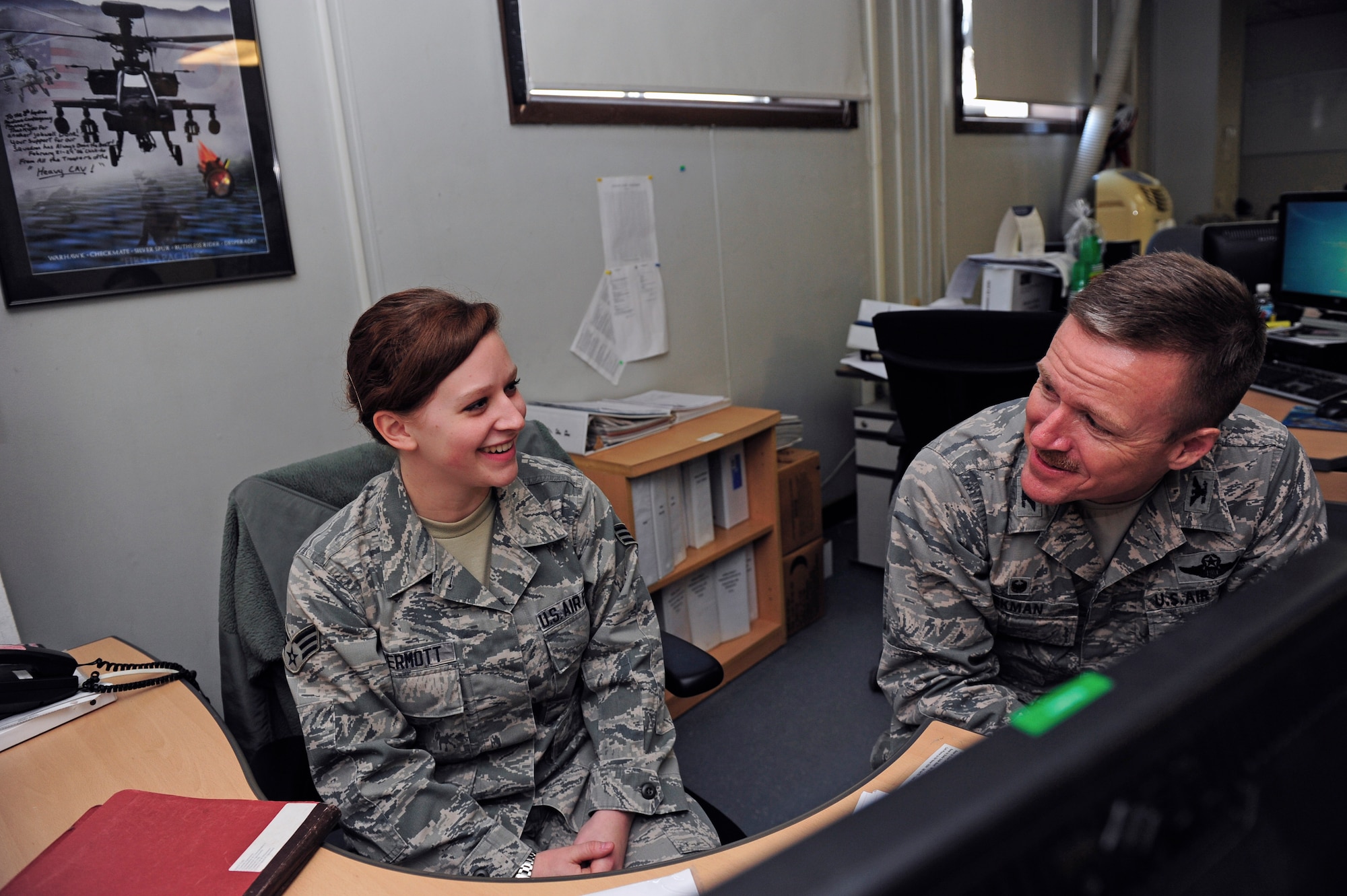 Senior Airman Sarah McDermott, 8th Logistics Readiness Squadron logistics planner, interacts with Col. Ken “Wolf” Ekman, 8th Fighter Wing commander, at Kunsan Air Base, Republic of Korea, March 25, 2015. McDermott showed Wolf how she contributes to the Wolf Pack mission. (U.S. Air Force photo by Senior Airman Taylor Curry/Released) 