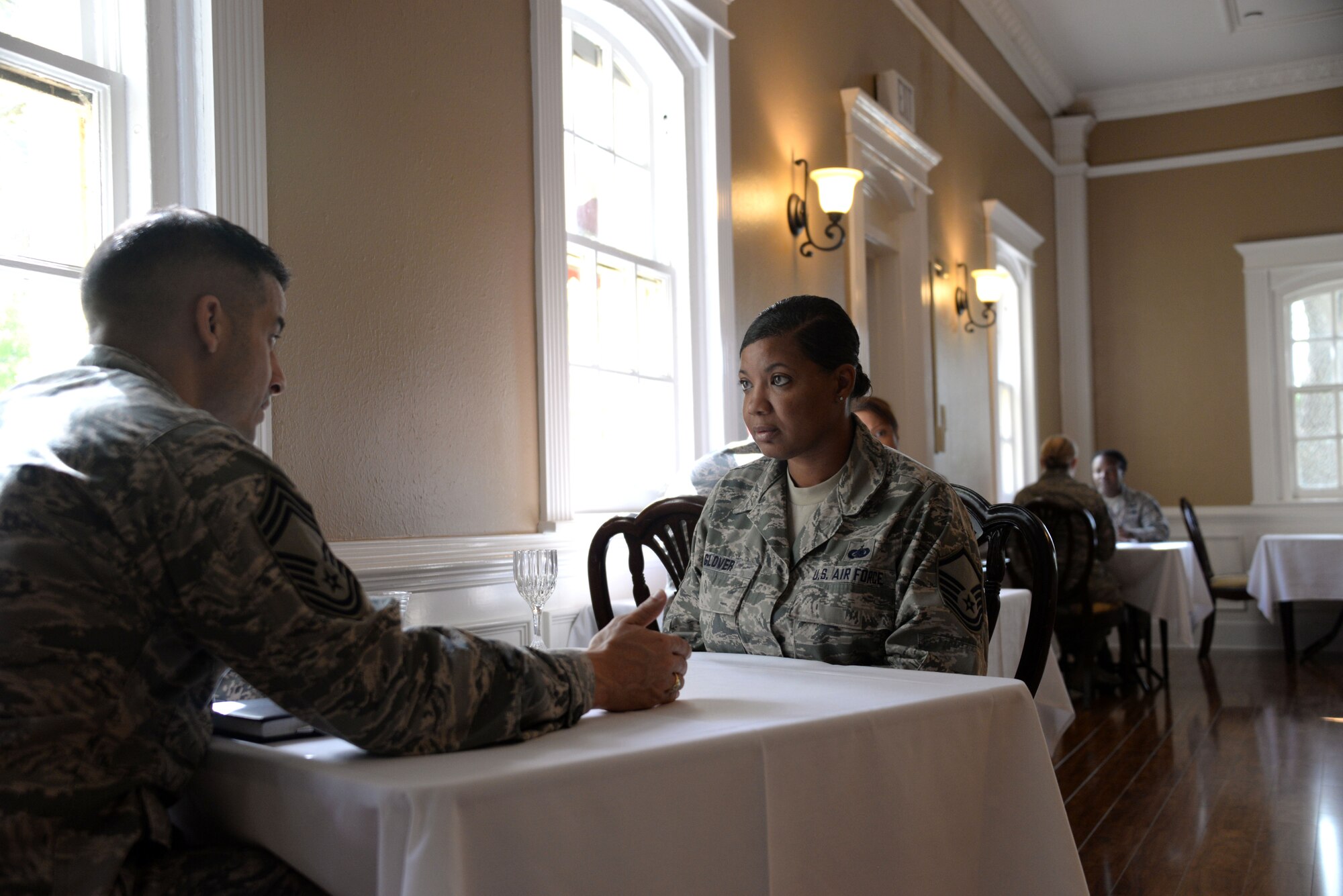 Master Sgt. Susan Glover, Air University Headquarters project integration manager, receives mentoring from Chief Master Sgt. Ben Caro, Senior Non-Commissioned Officer Academy commandant, during the Maxwell Top 3 ‘speed mentoring’ event April 2, 2015, at the Maxwell Club, Maxwell Air Force Base, Alabama. Eight chief master sergeants had five minutes with senior NCO attendees to discuss workplace issues or provide personal mentorship. (U.S. Air Force photo by Airman 1st Class Alexa Culbert)