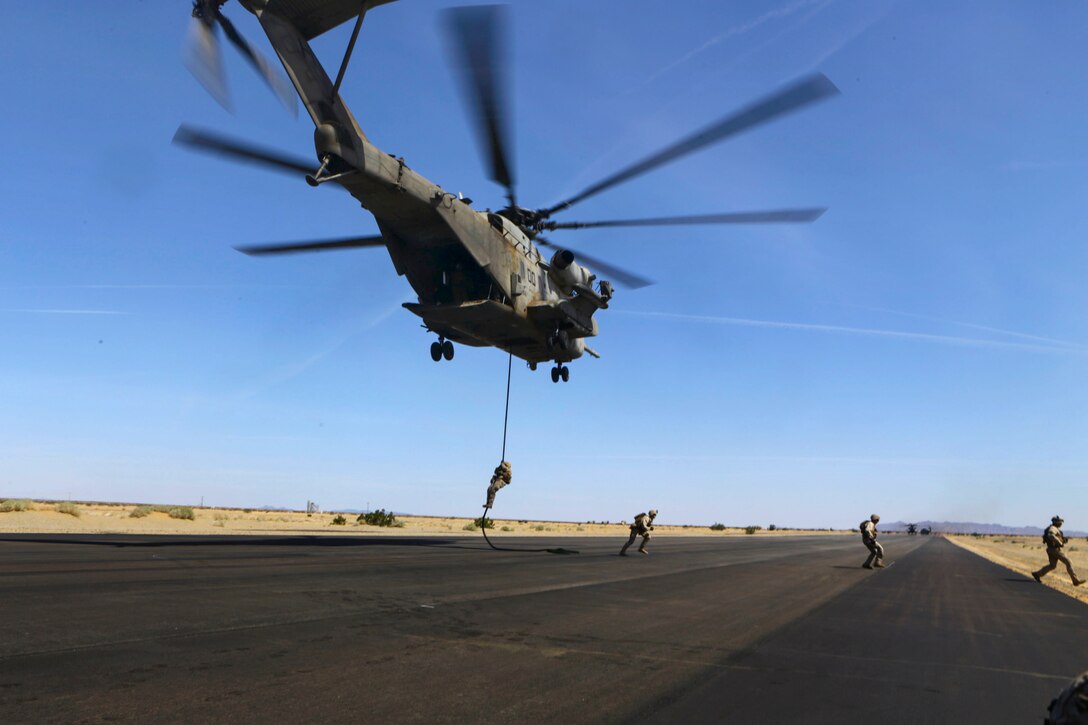 Marines conduct fast-rope training from a CH-53E Super Stallion helicopter on Auxiliary Airfield 2 near Yuma, Ariz., April 3, 2015.