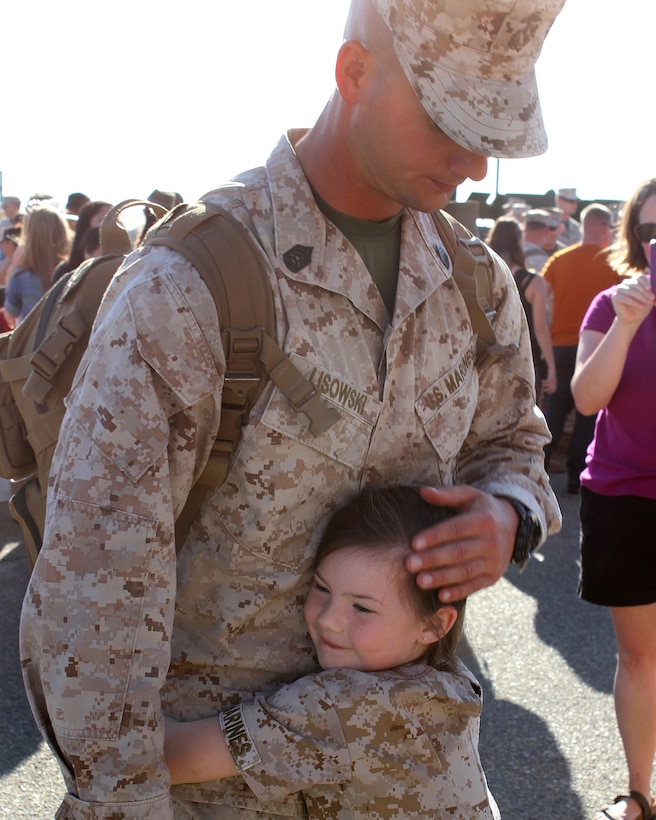 Marine Corps Gunnery Sgt. Derek Lisowski receives an embrace from his daughter upon returning to Camp Pendelton, Calf., April 4, 2015, after a seven-month deployment with Special Purpose Marine Air-Ground Task Force Crisis Response in the U.S. Central Command area of responsibility.