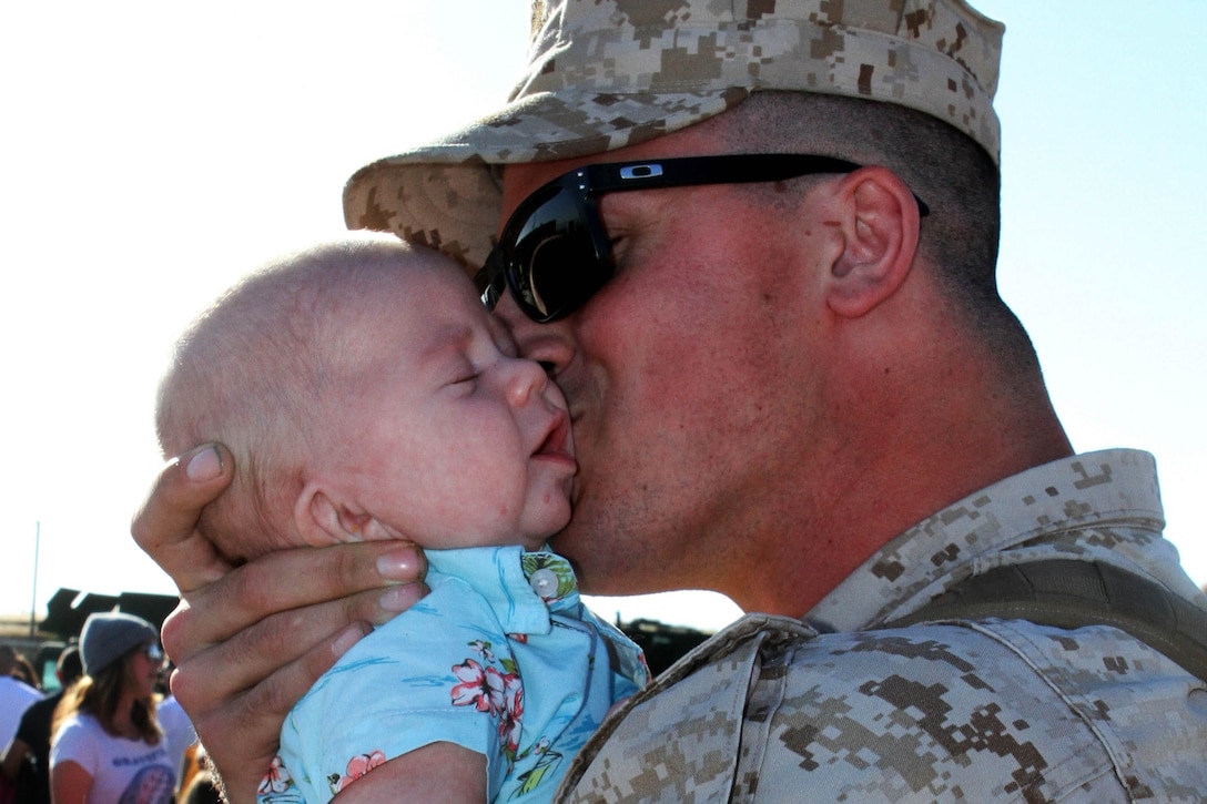 Marines Corps Cpl. Jordan Claspell meets his 2-month-old son, Elijah, for the first time upon his return to Camp Pendleton, Calif., April 4, 2015, from a seven-month deployment with Special Purpose Marine Air-Ground Task Force Crisis Response in the U.S. Central Command area of responsibility.