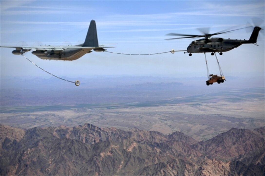 A Marine CH-53E Super Stallion helicopter conducts aerial refueling during slingload training near Yuma, Ariz., April 3, 2015. The helicopter crew is assigned to Marine Heavy Helicopter Squadron 361. The exercise, part of a weapons and tactics course for instructors, provides standardized training and certification to support Marine aviation training and readiness.