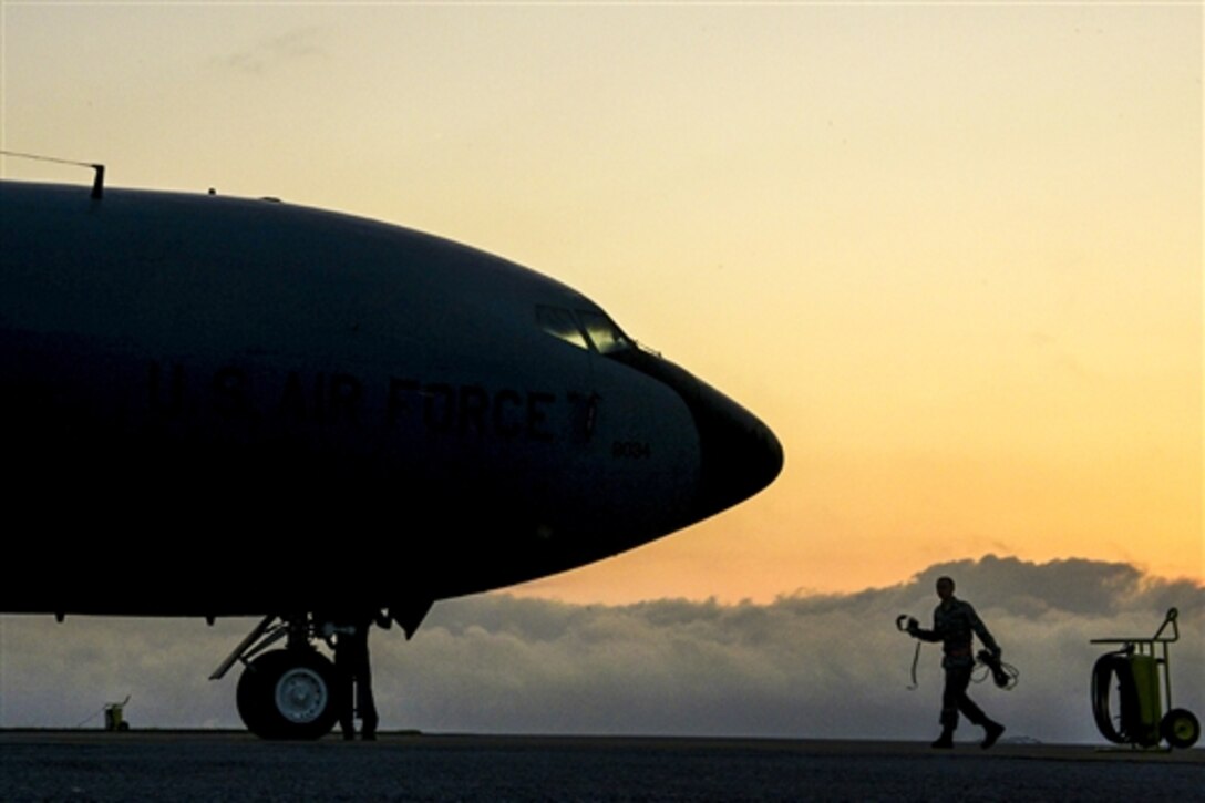 A U.S. airman walks toward a KC-135 Stratotanker refueling aircraft during Forceful Tiger, an exercise on Kadena Air Base, Japan, April 1, 2015. The airmen is assigned to the 909th Aircraft Maintenance Unit. The KC-135 is assigned to the 909th Air Refueling Squadron.