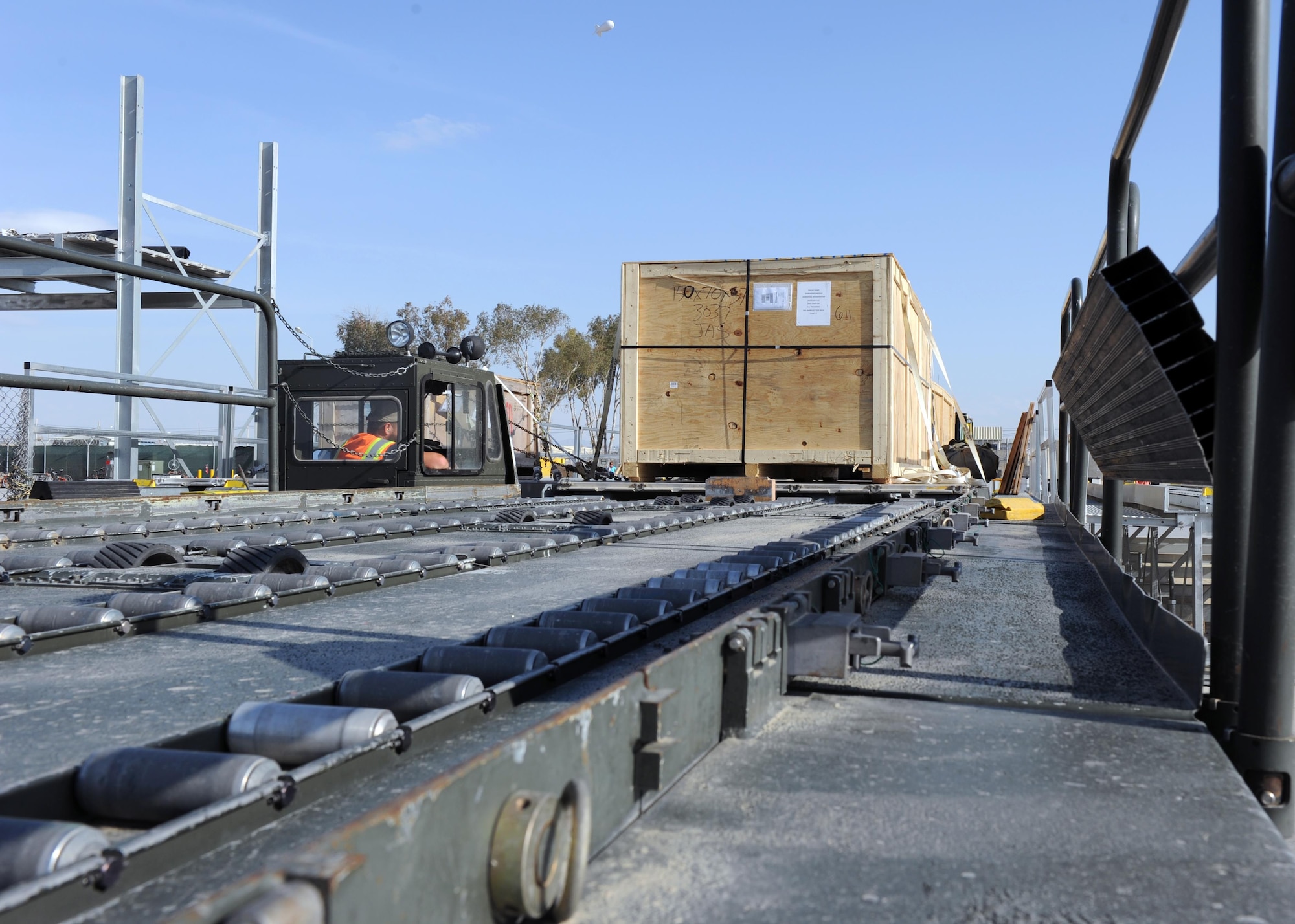 A crate sits on a K loader prior to being transported to an aircraft in support of retrograde operations March 20, 2015 at Kandahar Airfield, Afghanistan. At the height of retrograde in 2014, Airmen assigned to the 451st Expeditionary Logistics Readiness Squadron were responsible for shipping more than 9,000 tons of cargo each month. (U.S. Air Force photo by Staff Sgt. Whitney Amstutz/released)