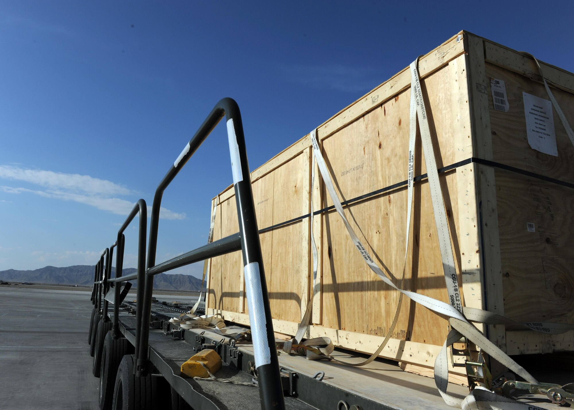 A crate sits on a K loader prior to being transported to an aircraft in support of retrograde operations March 20, 2015 at Kandahar Airfield, Afghanistan. At the height of retrograde in 2014, Airmen assigned to the 451st Expeditionary Logistics Readiness Squadron were responsible for shipping more than 9,000 tons of cargo each month. (U.S. Air Force photo by Staff Sgt. Whitney Amstutz/released)