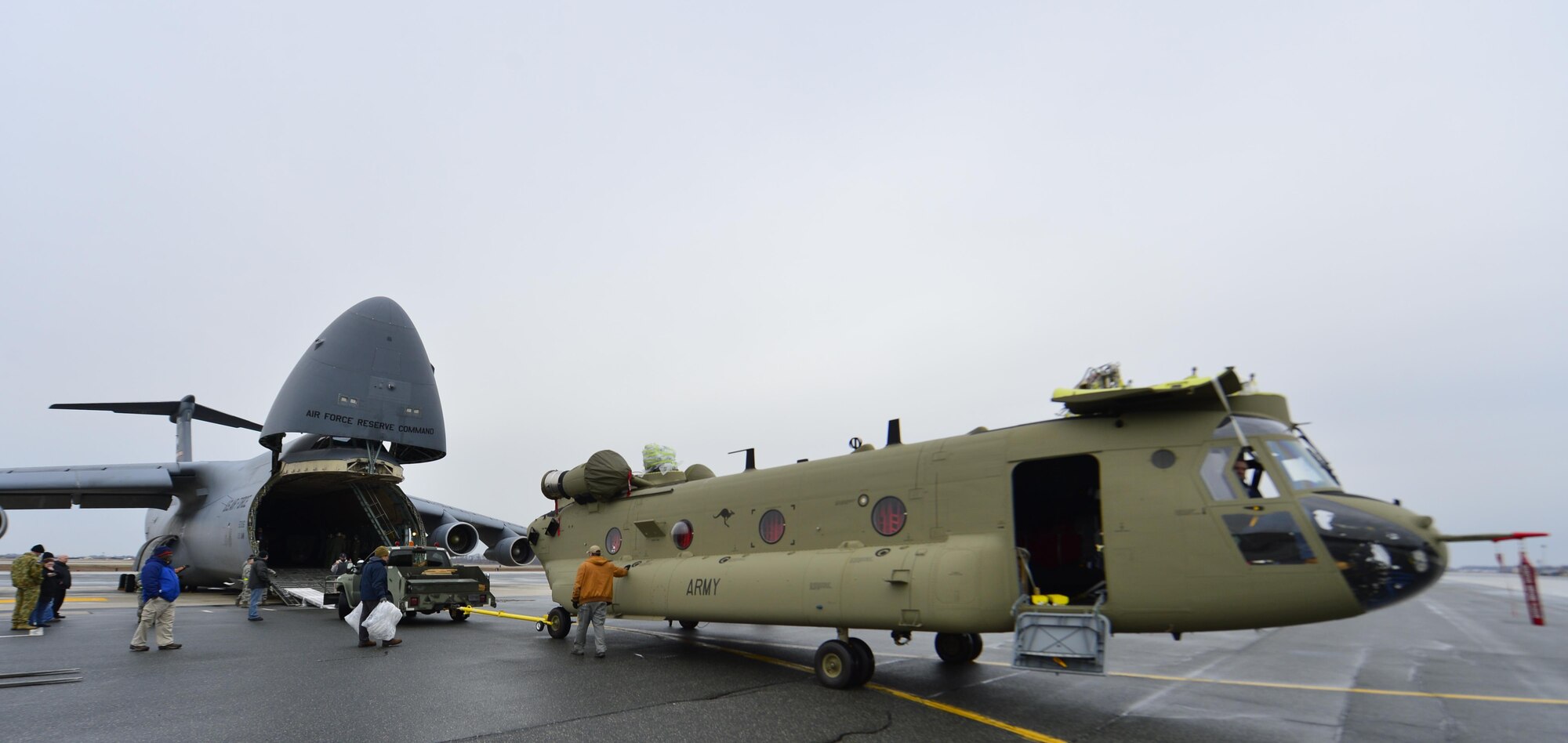 Members of Team Dover and the 337th Airlift Squadron,  Westover Air Reserve Base, Mass., load two Boeing Chinook CH-47Fs into a C-5 Super Galaxy March 27, 2015, at Dover Air Force Base, Del. Each helicopter weighted just shy of 24,000 pounds and were being shipped to the Australian Army. (U.S. Air Force photo/Airman 1st Class William Johnson)