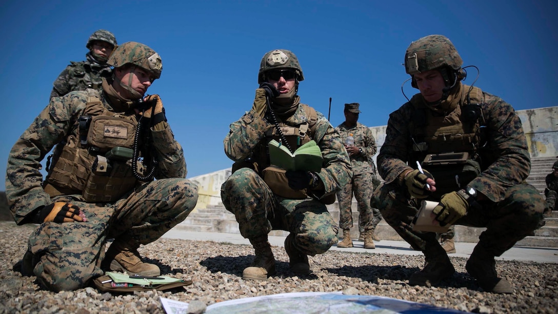 U.S. Marines Cpl. Michael G. Dempich, left, Gunnery Sgt. James W. Clingan, center, and Capt. Joseph R. Mozzi coordinate integrated fire via radio with pilots and troops on the ground March 24 at Susungri Range in Pohang, South Korea. The Marines completed a week of fire support coordination training with Republic of Korea Marines as part of Korean Marine Exchange Program 15-14.2, a small-unit training exercise, which enhances the combat readiness and interoperability of the two forces. Dempich, from Whitewater, Wisconsin, is a fire support man with 5th Air Naval Gunfire Liaison Company, III Marine Expeditionary Force Headquarters Group, III MEF. Clingan, from Milford, Delaware, is a fire support man with the company. Mozzi, from Dalton, Massachusetts, is a joint terminal attack controller with the company. 