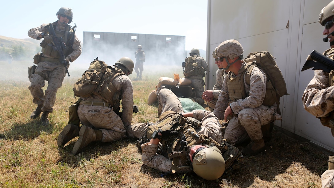 Marines with Charlie Company, 1st Reconnaissance Battalion, provide medical aid to a simulated casualty during a live-fire raid at Range 226 aboard Marine Corps Base Camp Pendleton, California, April 1, 2015. The company conducted the live-fire exercise as part of a pre deployment workup in support of the 13th Marine Expeditionary Unit. (U.S. Marine Corps photo by Sgt. Joseph Scanlan / released)